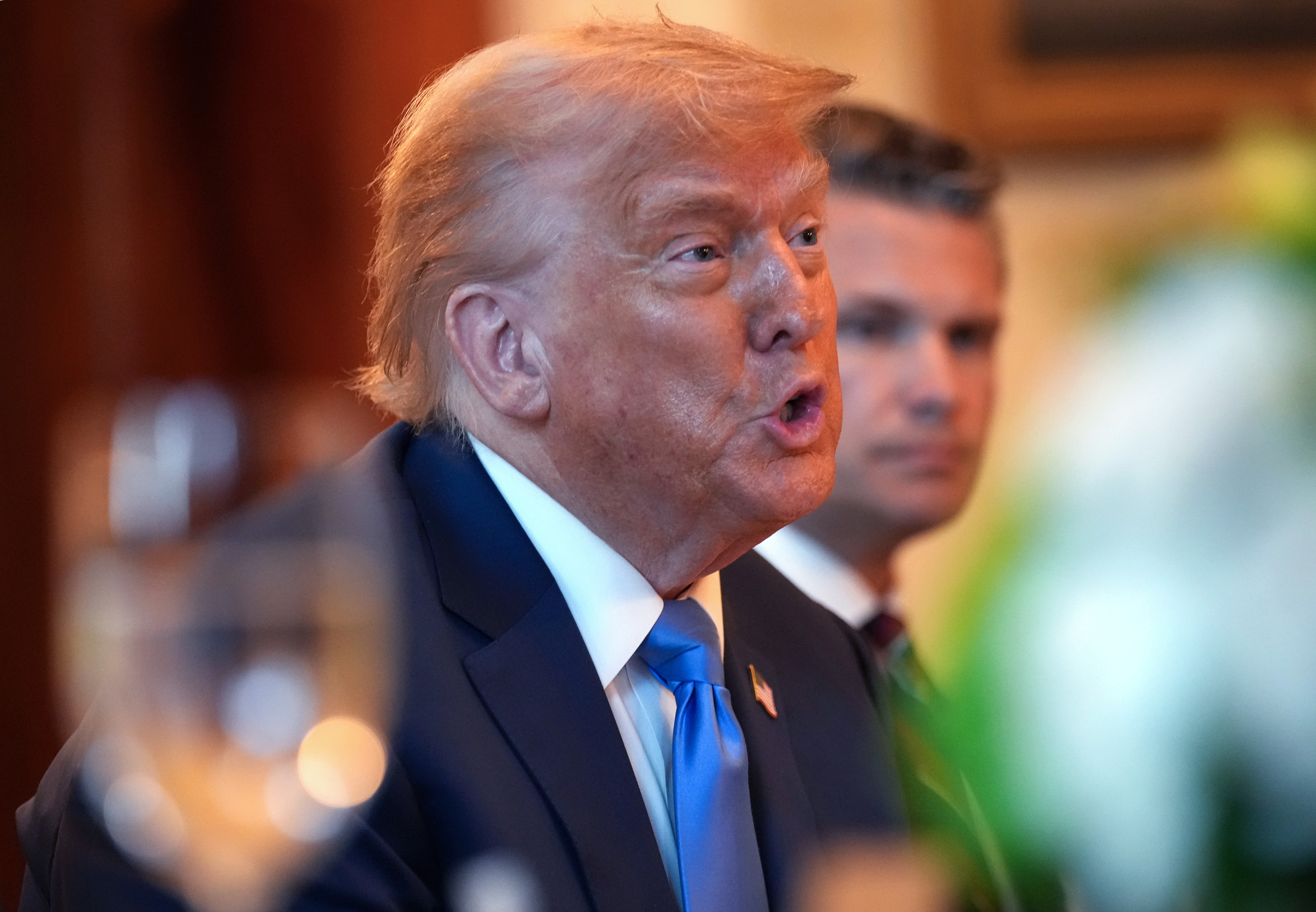 President Donald Trump had Defense Secretary Pete Hegseth to his left at the dinner table