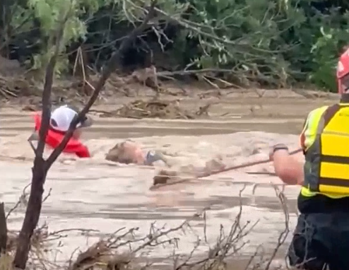Residents cling to rope as Texas floodwater surges around them