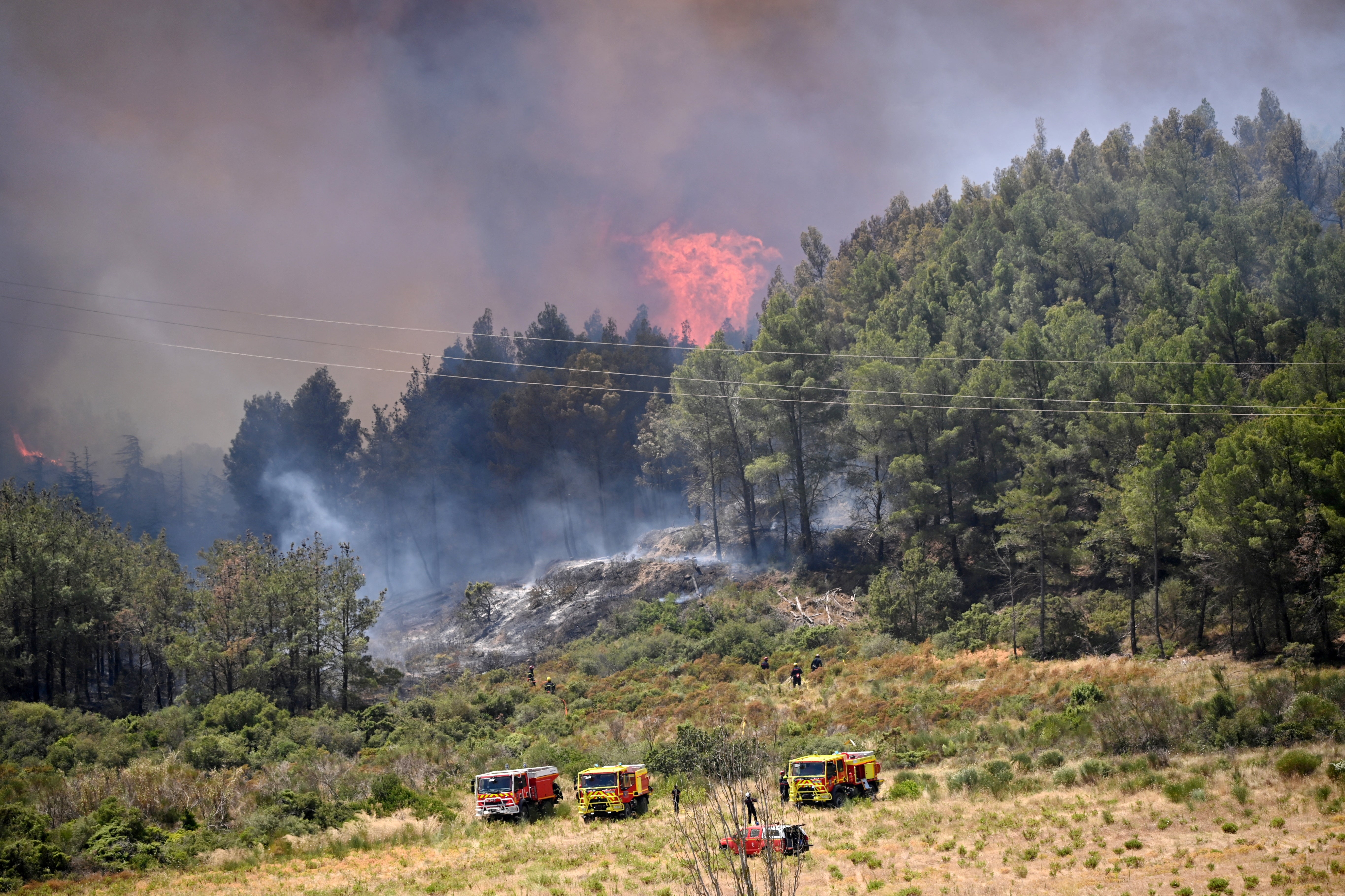 Firefighters work to contain the fire in southern France