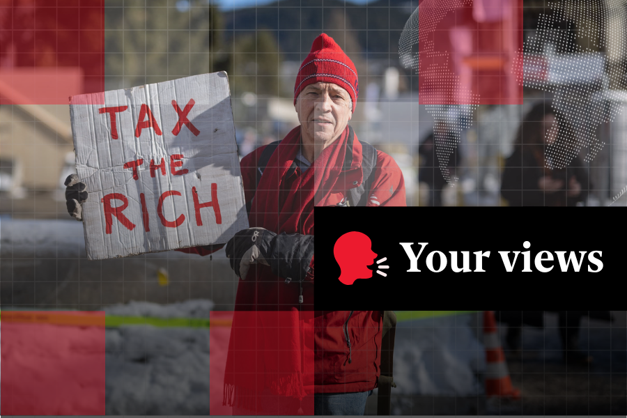 Phil White, a British millionaire poses with a placard reading: “Tax the rich"