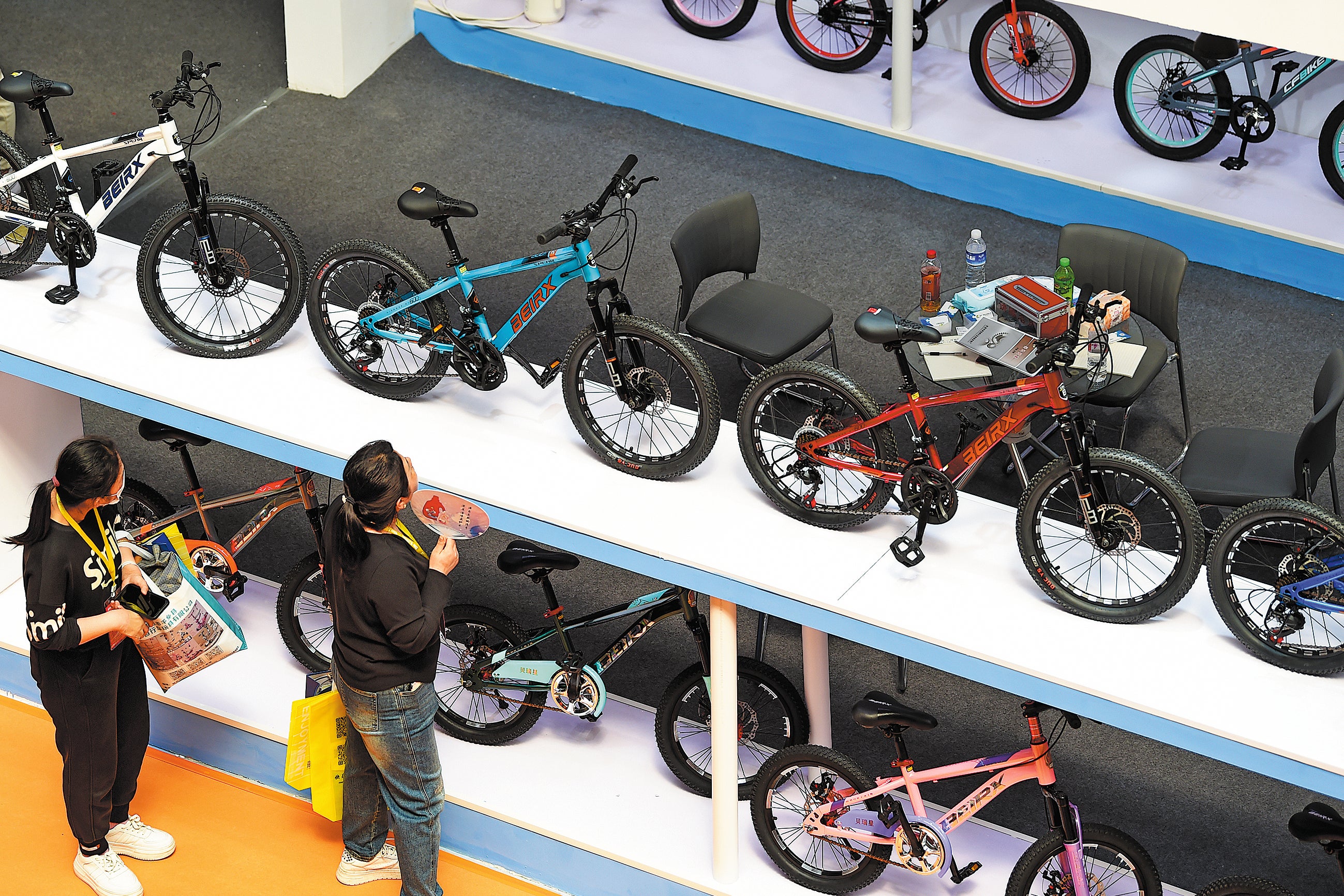 Visitors look at the bicycle products on display at the 17th International Bicycles, Baby Strollers and Toys Fair in Pingxiang county, Hebei province, in April last year