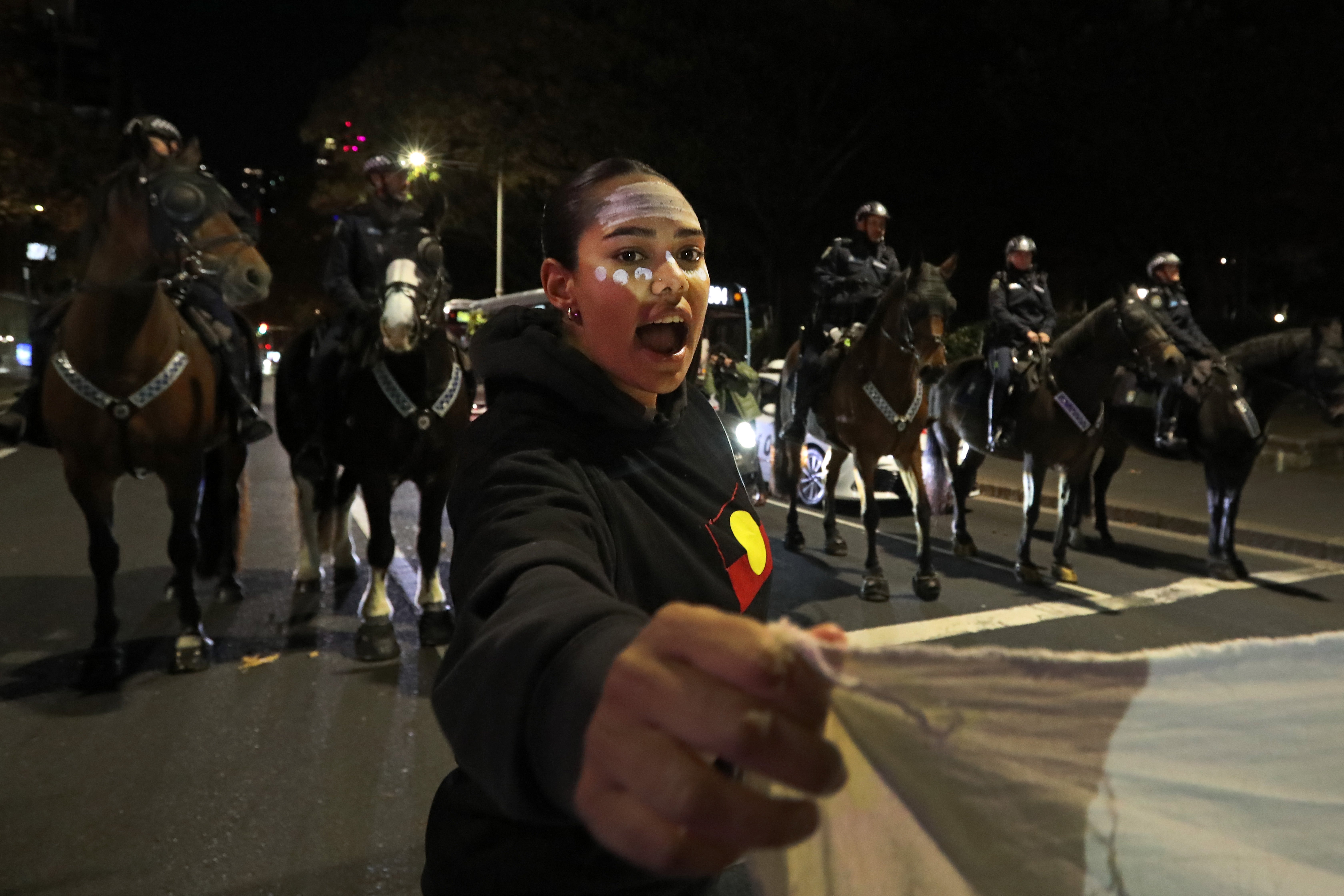 A protester stands in front of a police line during a march demanding action on Yuendumu deaths in police custody on 7 June 2025 in Sydney, Australia. A 24-year-old Warlpiri man, Kumanjayi White, died after being forcibly restrained by two plainclothes police officers at a Coles supermarket in Alice Springs on 27 May 2025, sparking national outrage and calls for an independent investigation into his death. His passing has deeply affected the Yuendumu community, coming just days before the delayed release of the inquest findings into the 2019 police shooting of another young Warlpiri man, Kumanjayi Walker, highlighting ongoing concerns about Aboriginal deaths in custody in the Northern Territory