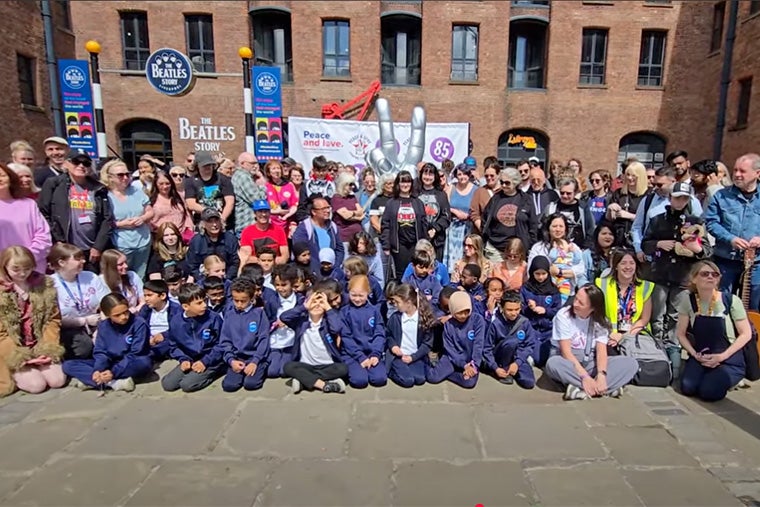 Students pose in front of the statue in Liverpool