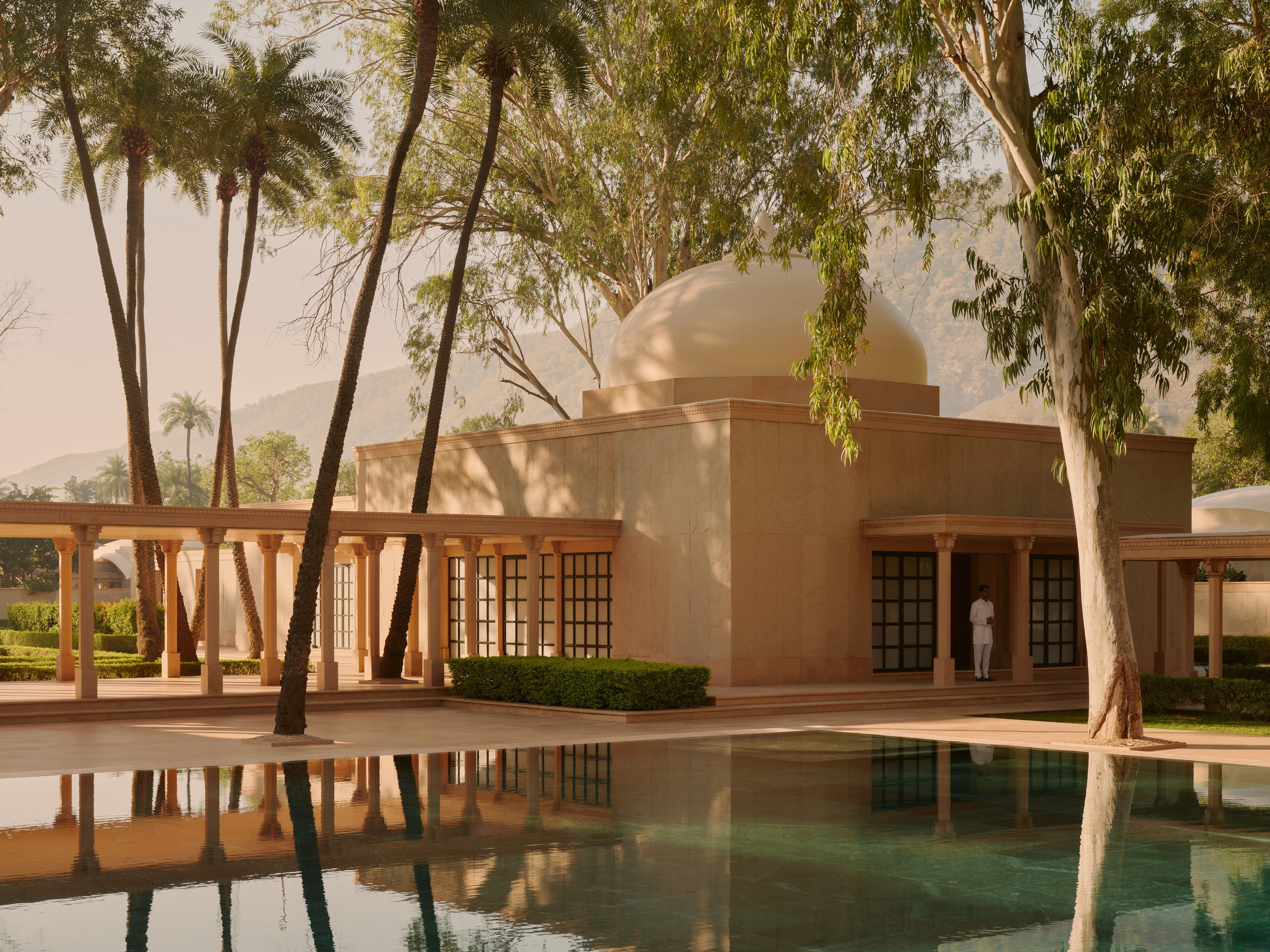 <p>Surrounded by palms and soundtracked by birdsong, you'd be hard pushed to find a more peaceful or picturesque pool than the one at Amanbagh hotel in India </p>