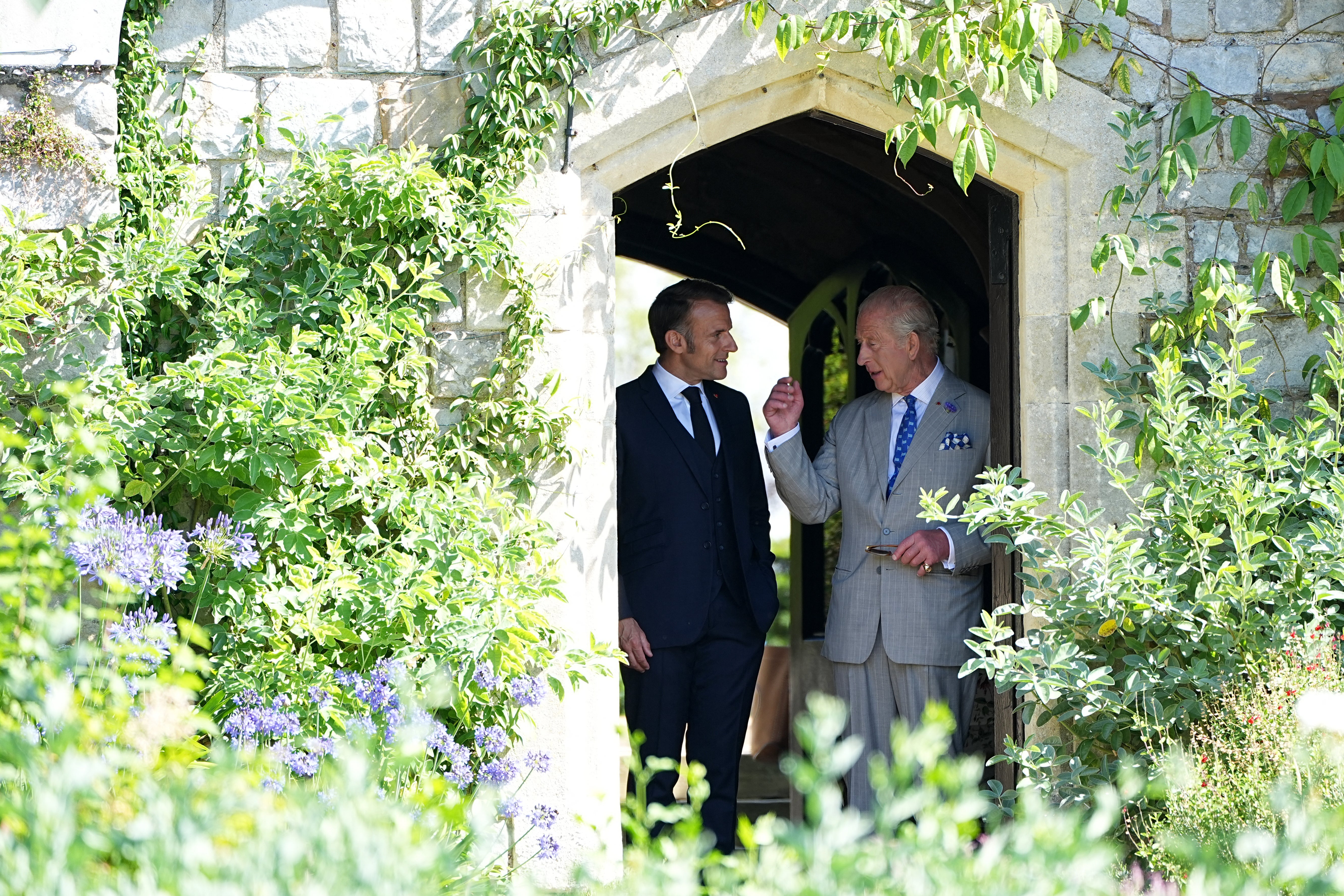 France's President Emmanuel Macron (L) and Britain's King Charles III visit the gardens of Windsor Castle, west of London, on July 9, 2025, on the second day of a three-day state visit to Britain. King Charles III and Emmanuel Macron both hailed the importance of UK-France relations as the French president paid a three-day formal visit to Britain, the first by an EU head of state since Brexit. (Photo by Aaron Chown / POOL / AFP) (Photo by AARON CHOWN/POOL/AFP via Getty Images)