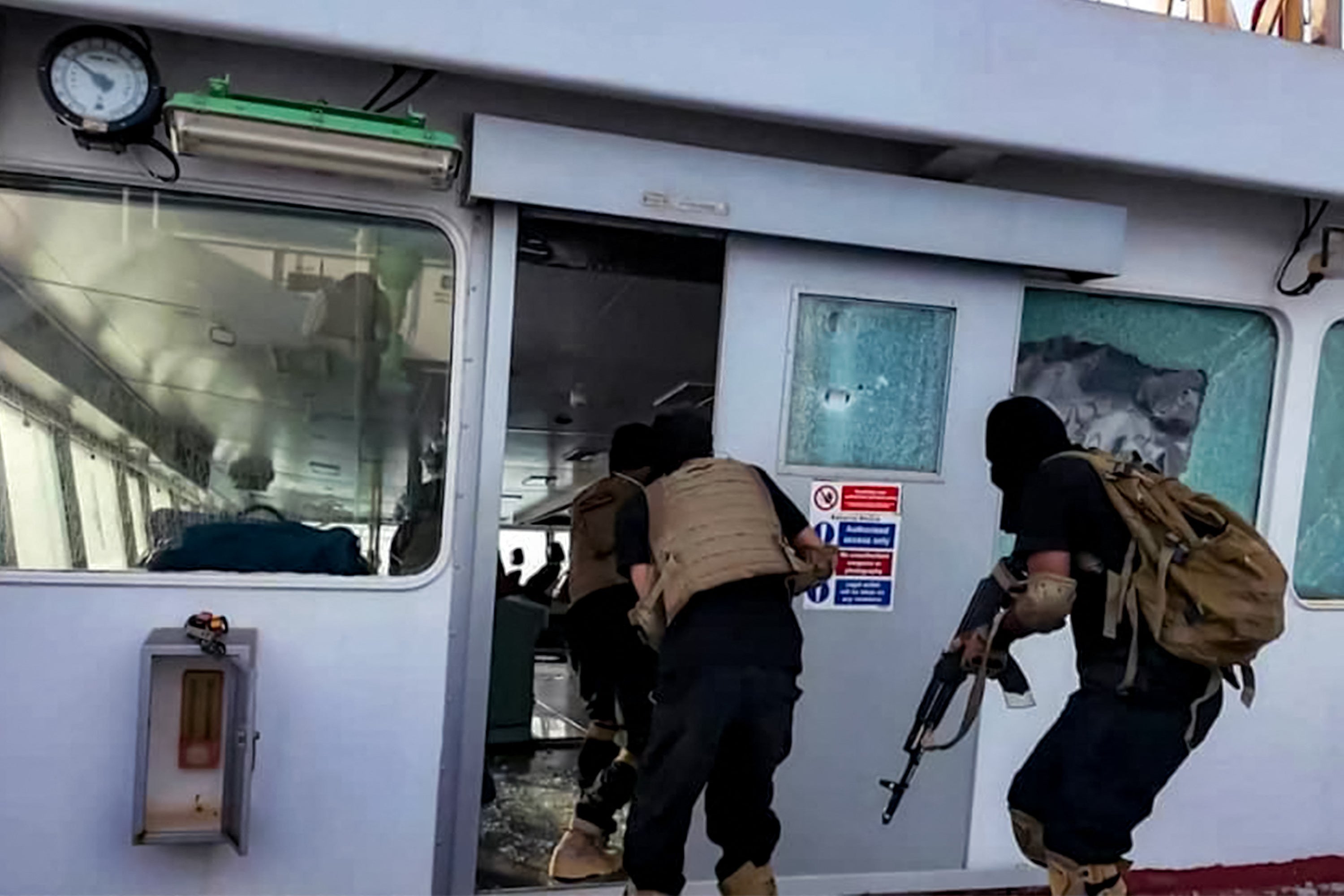 This handout picture released by Yemen's Houthi Ansarullah Media Centre on July 8, 2025 shows Houthi-affiliated fighters carrying out an attack on the Liberia-flagged bulk carrier Magic Seas at sea.