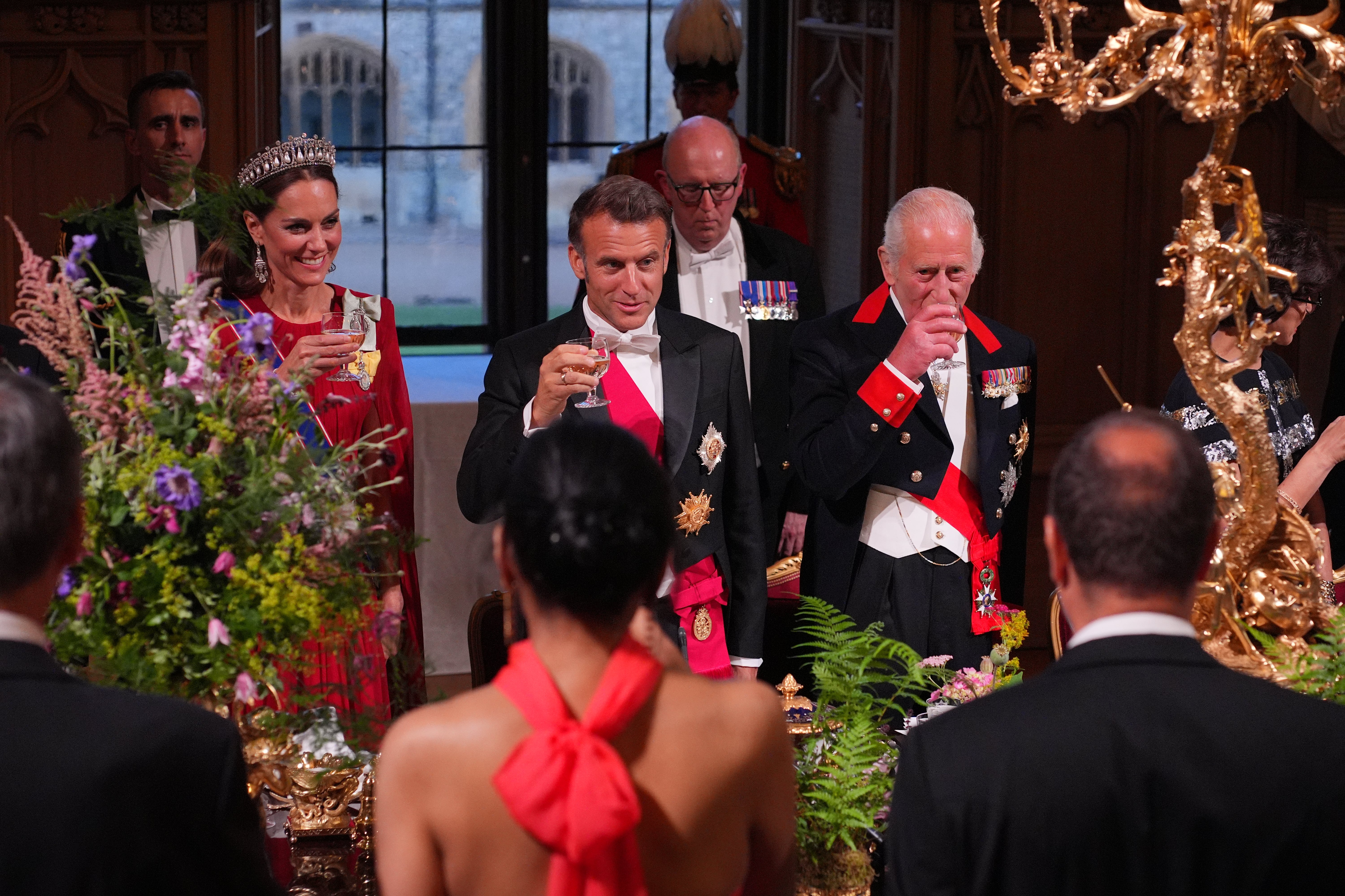 The Princess of Wales looks on as King Charles and Emmanuel Macron toast at the state banquet