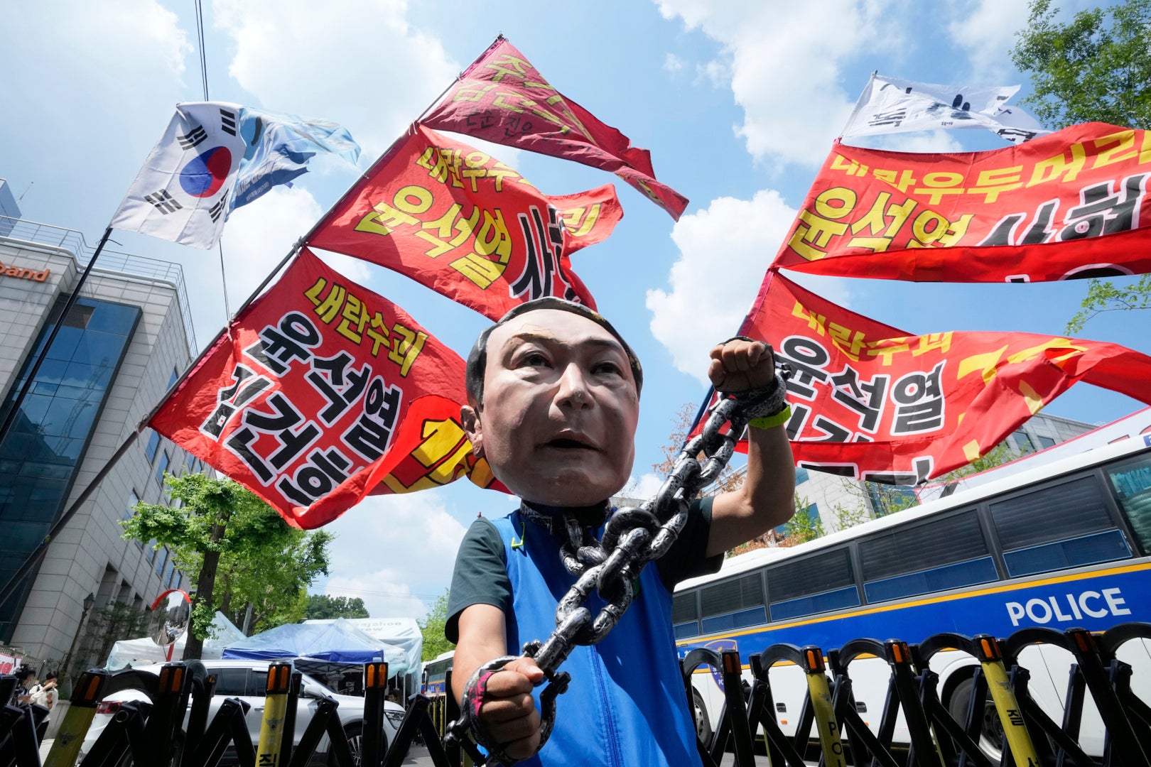 A protester wears a mask of Yoon Suk Yeol during a rally in support of a hearing to review a special prosecutor's request for his arrest on 9 July 2025