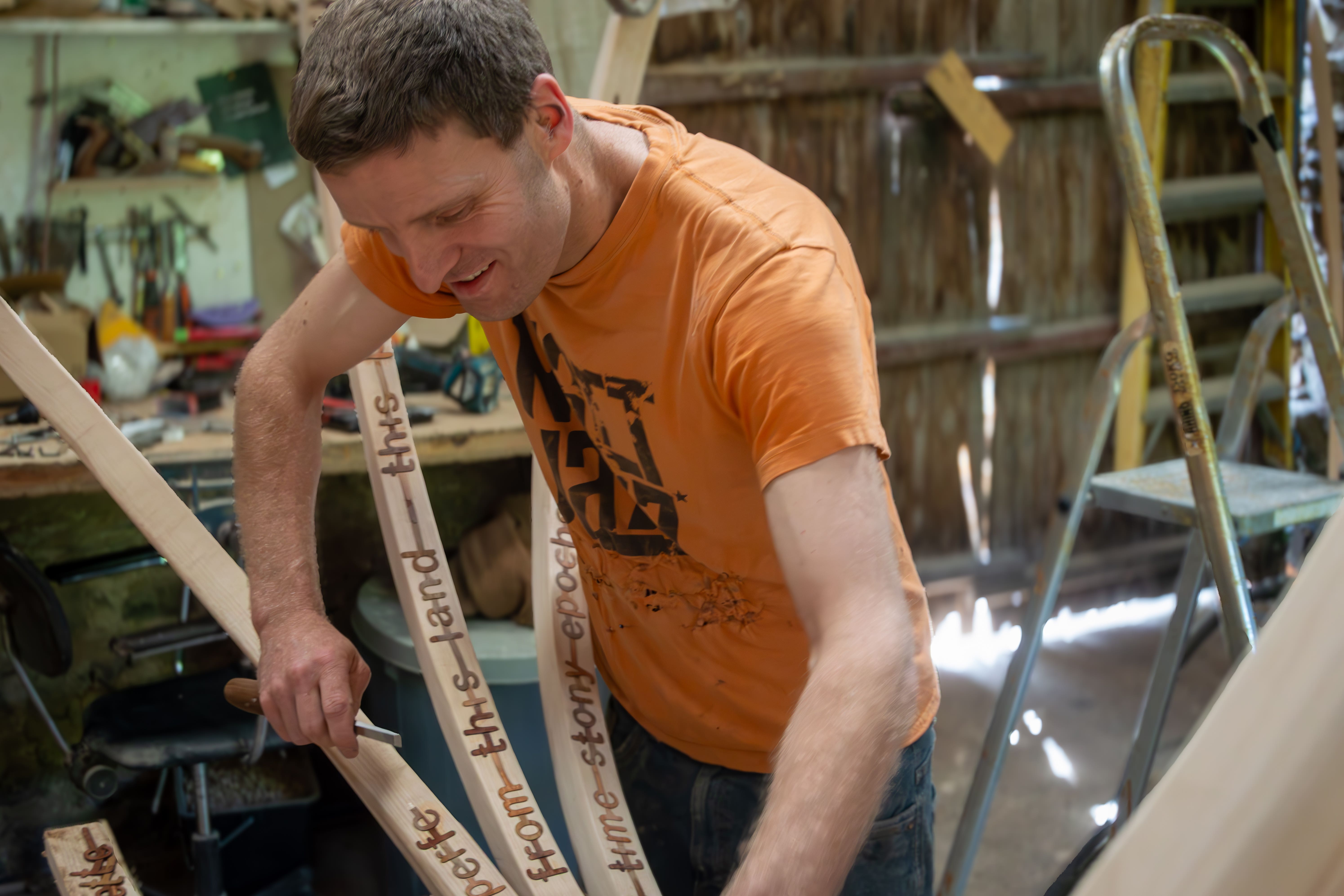 Sculptor Charlie Whinney’s new installation uses a section of the Sycamore Gap tree (Jessica Wade-Slee/Northumberland National Park Authority/PA)