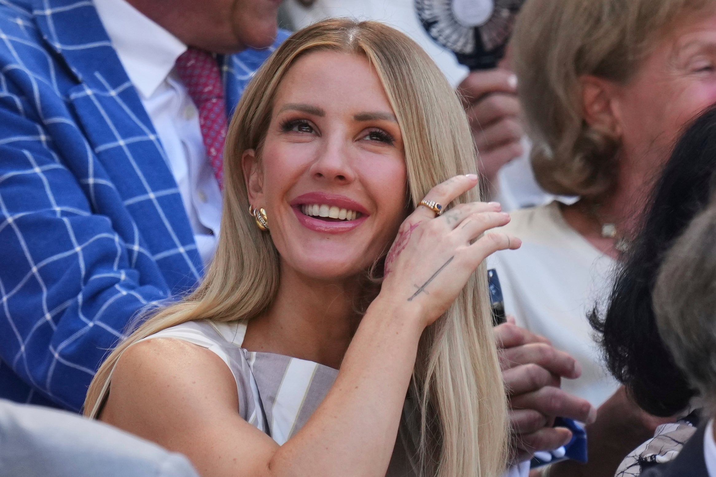 Singer Ellie Goulding sits in the stands