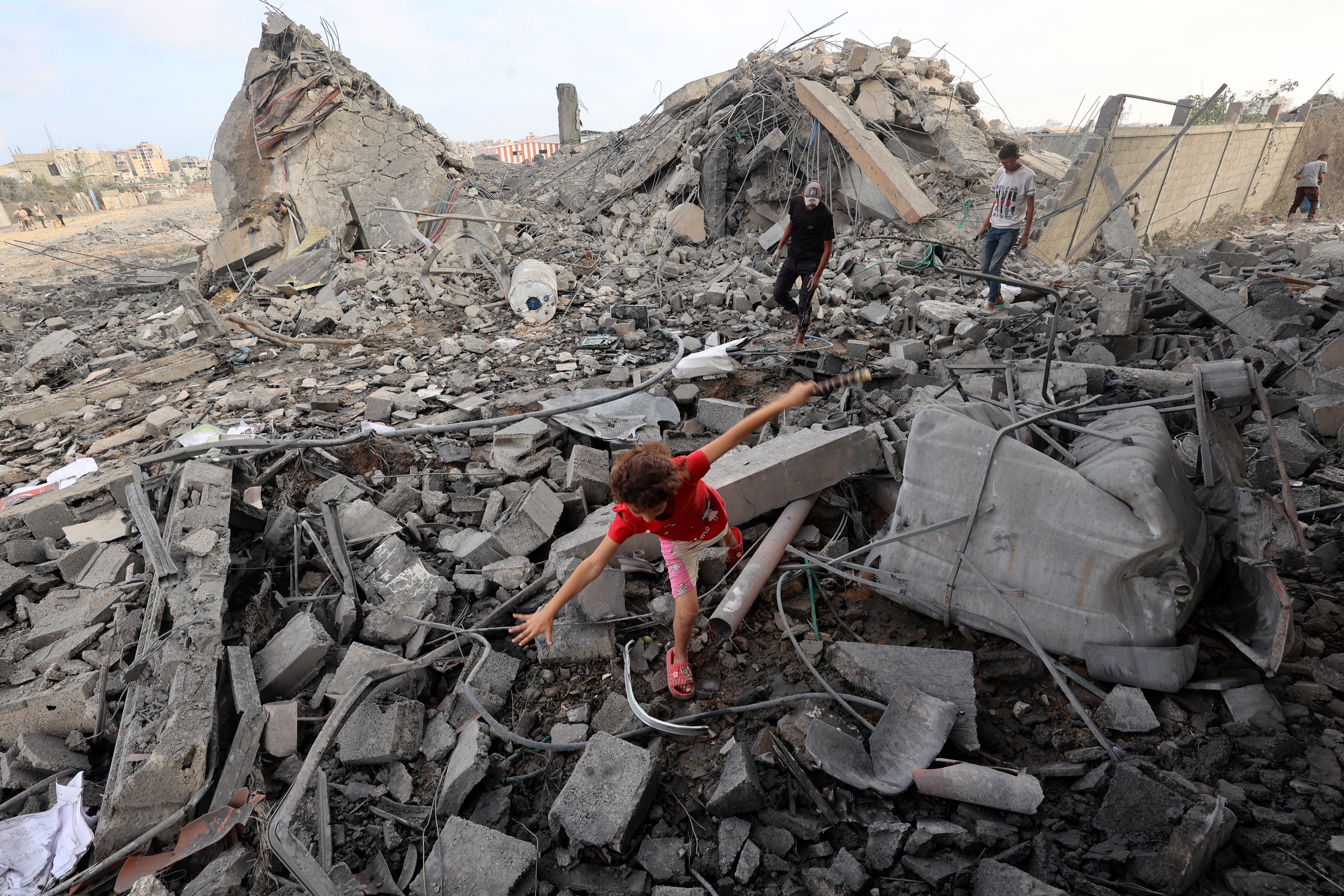 A Palestinian child in the rubble of a building hit by an Israeli strike in the Bureij refugee camp in central Gaza