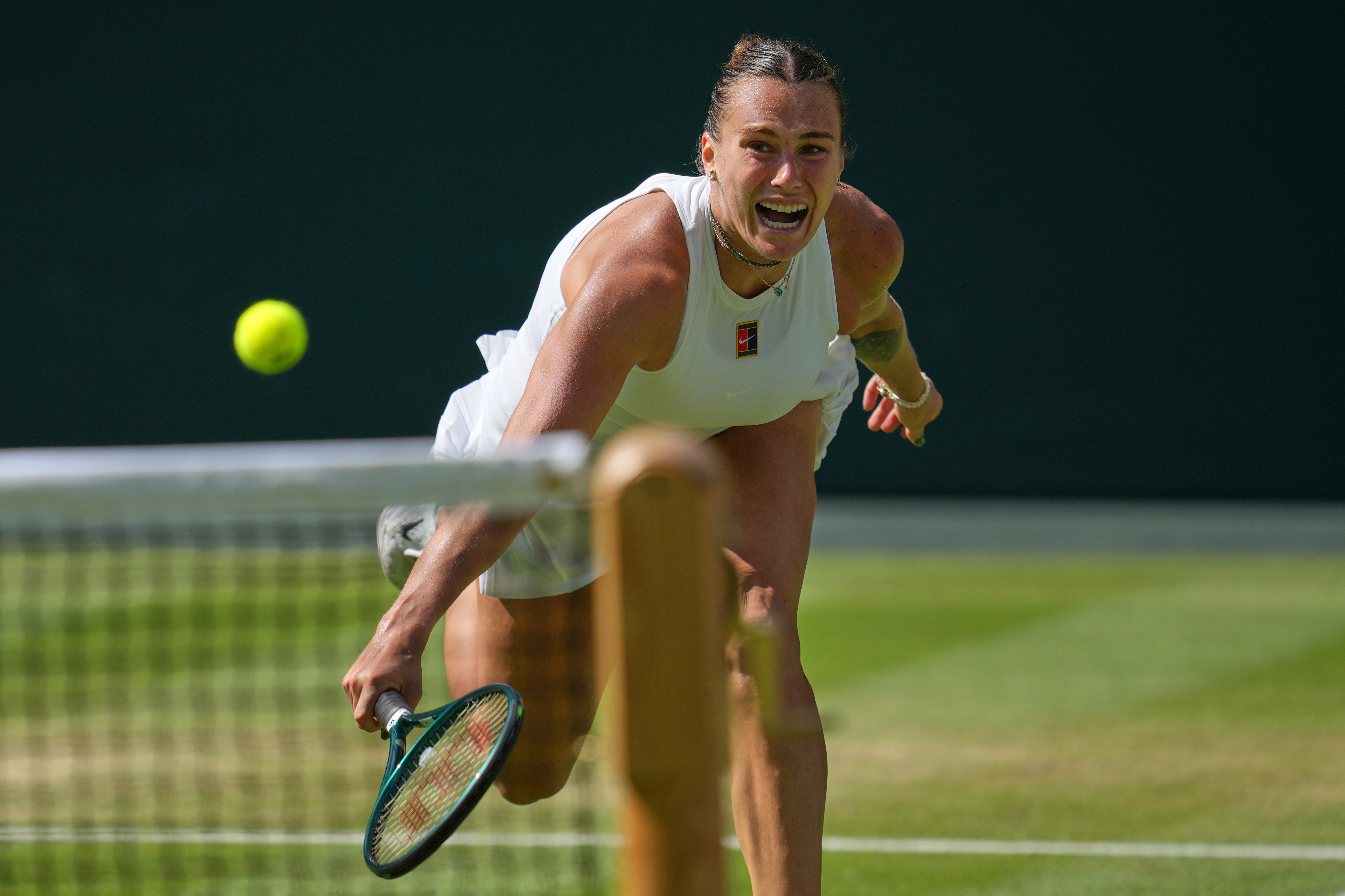 Sabalenka struggling to return a shot by Anisimova