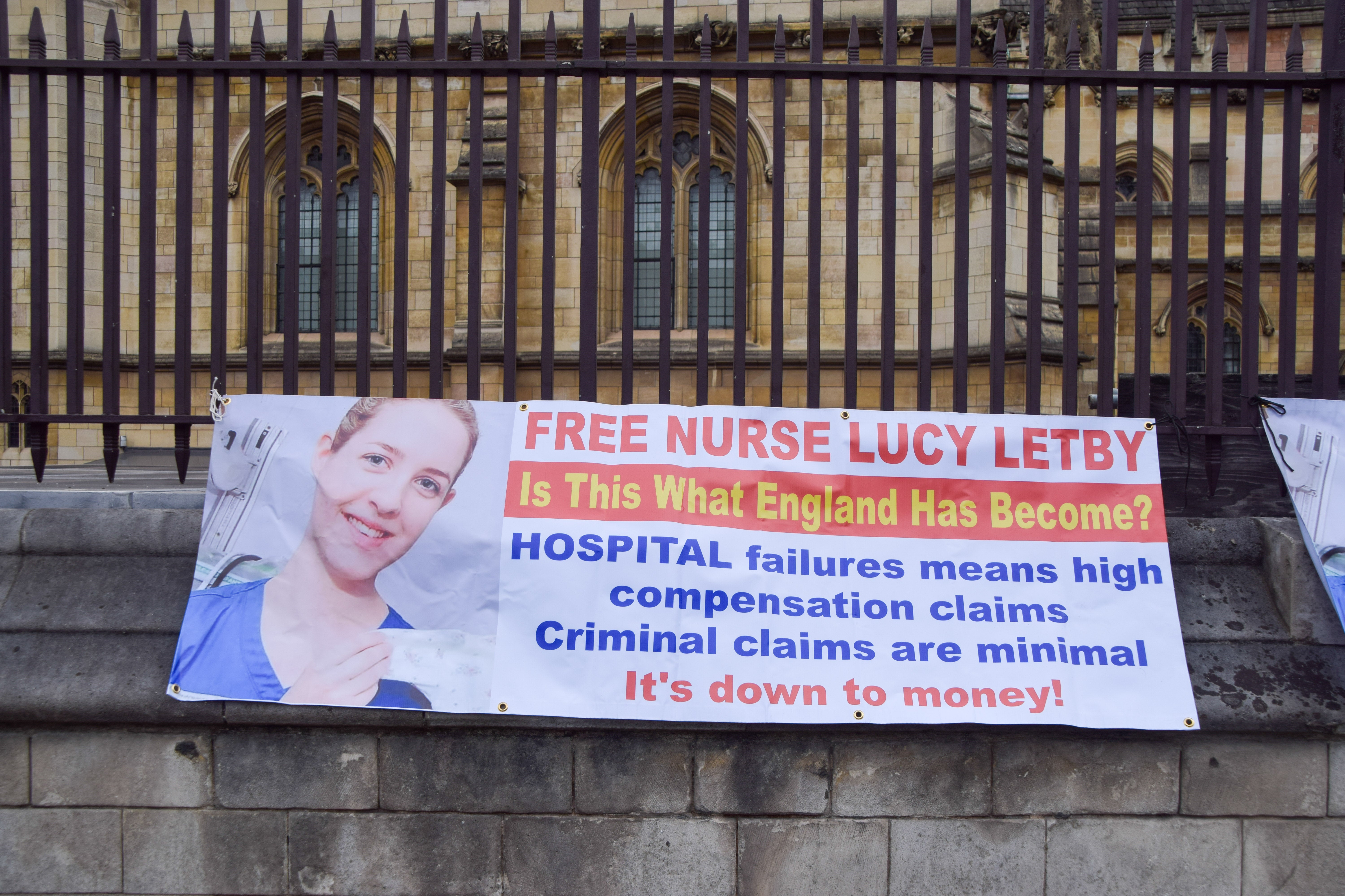 Pro-Letby supporters hang signs outside parliament demanding the nurse’s freedom
