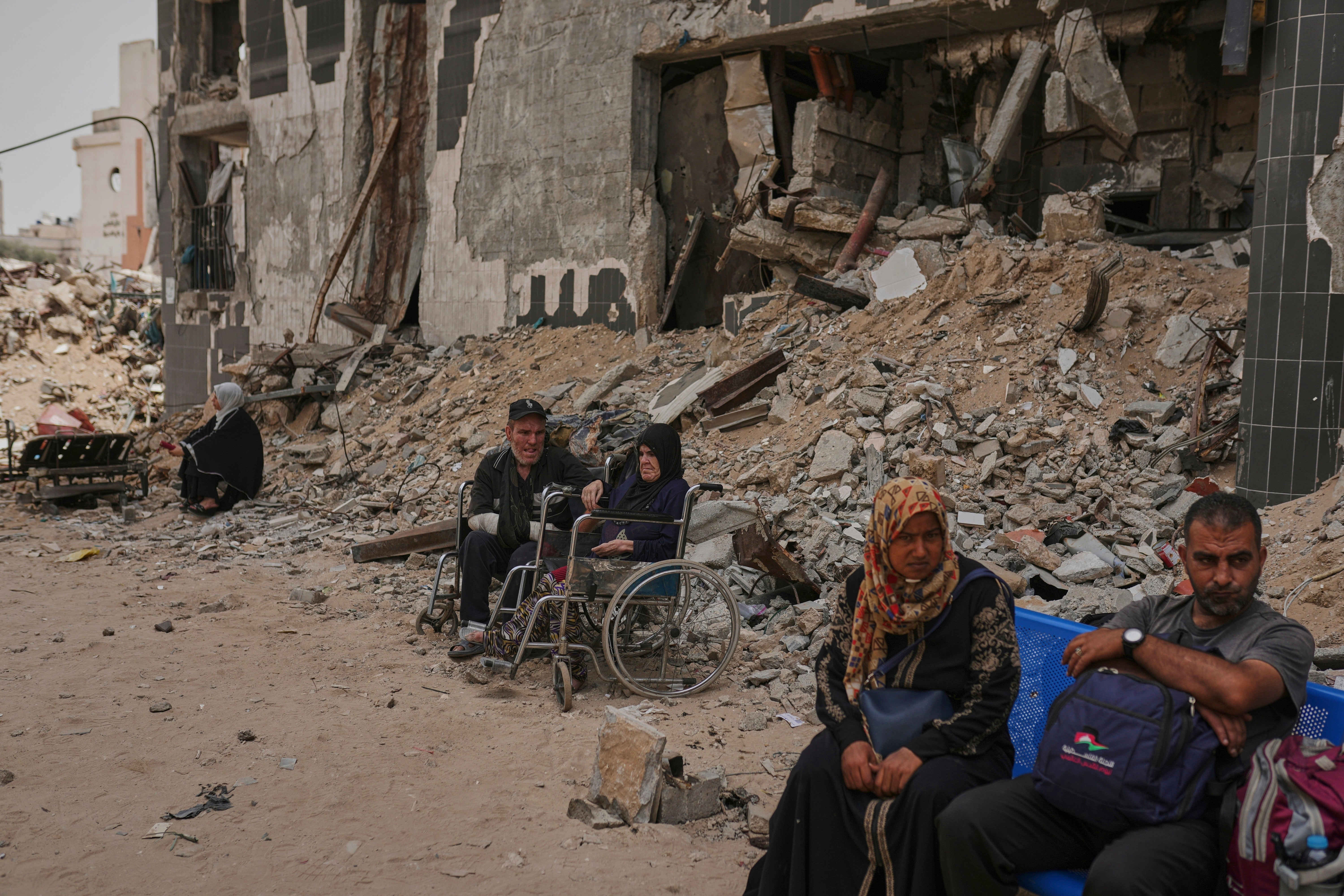 Kidney patients sit amid rubble left by an Israeli strike after the Shifa Hospital’s dialysis unit suspended its services due to fuel shortages in Gaza City on 1 July 2025