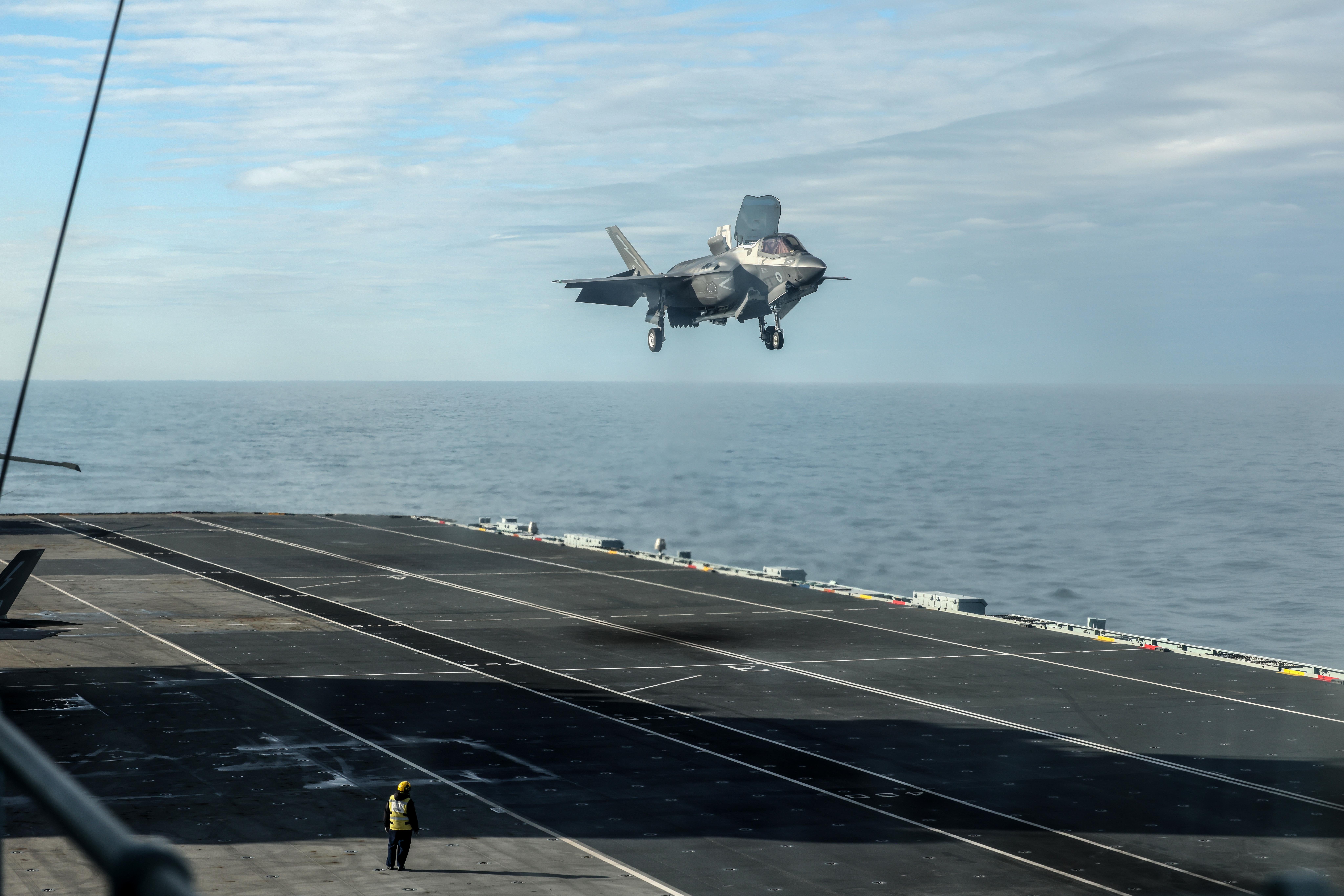 An F-35 fighter hovers over the deck of HMS Prince of Wales (Richard Pohle/The Times/PA)