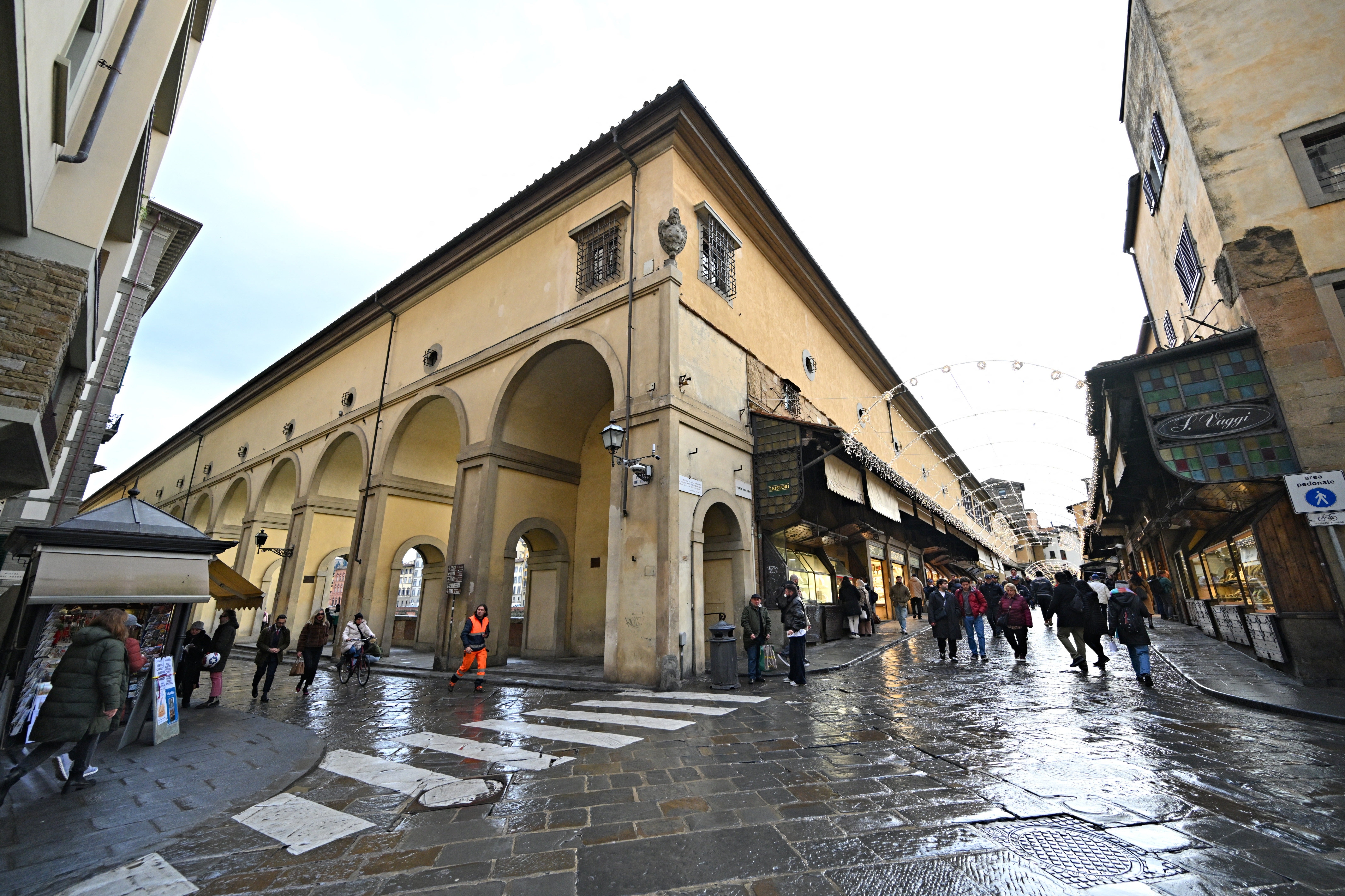 A view of the Vasari Corridor, with the arches and windows positioned high along the route, along the banks of the River Arno and above the Ponte Vecchio in central Florence