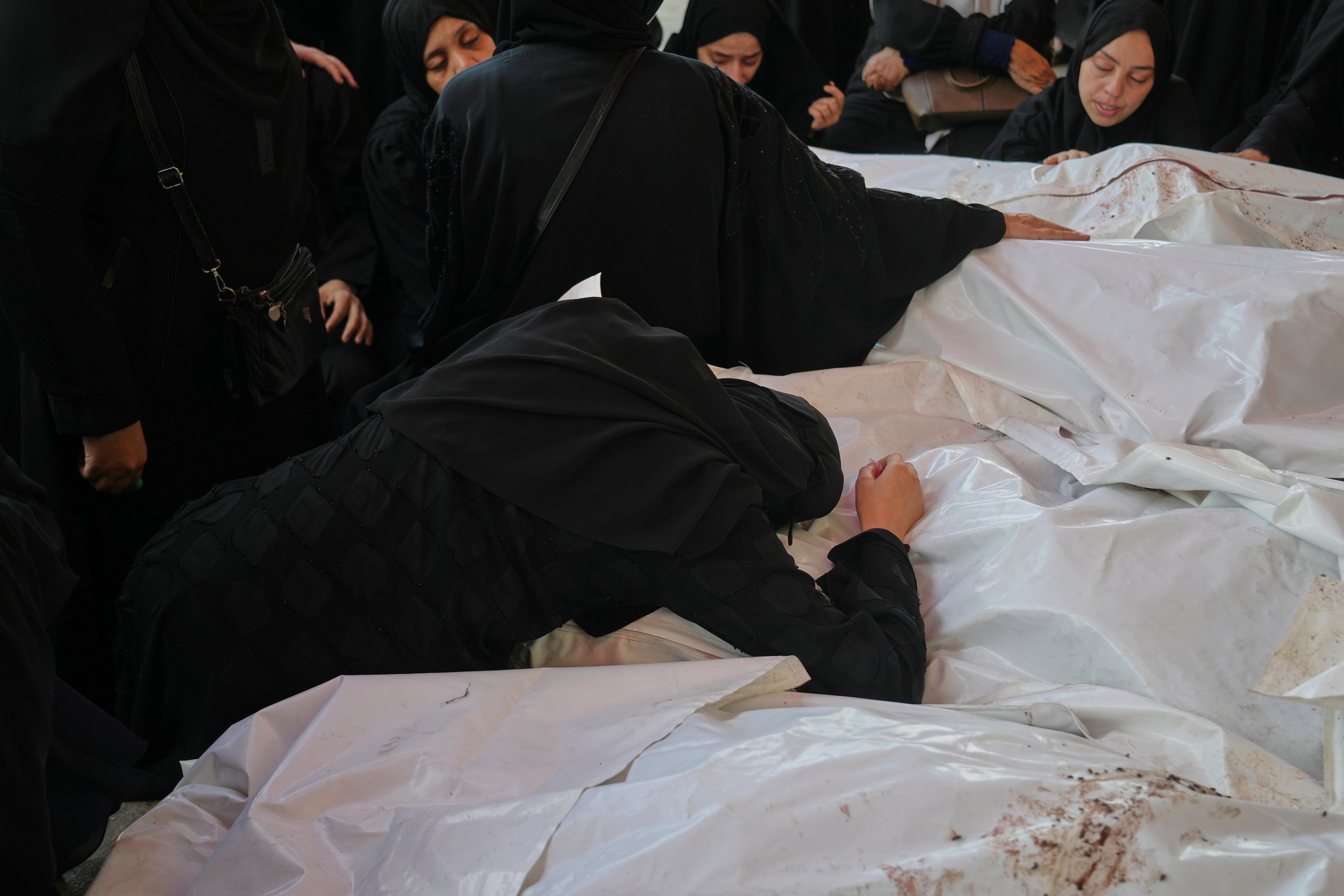 Children and two women were among at least 13 people who were killed in Deir al-Balah, in central Gaza