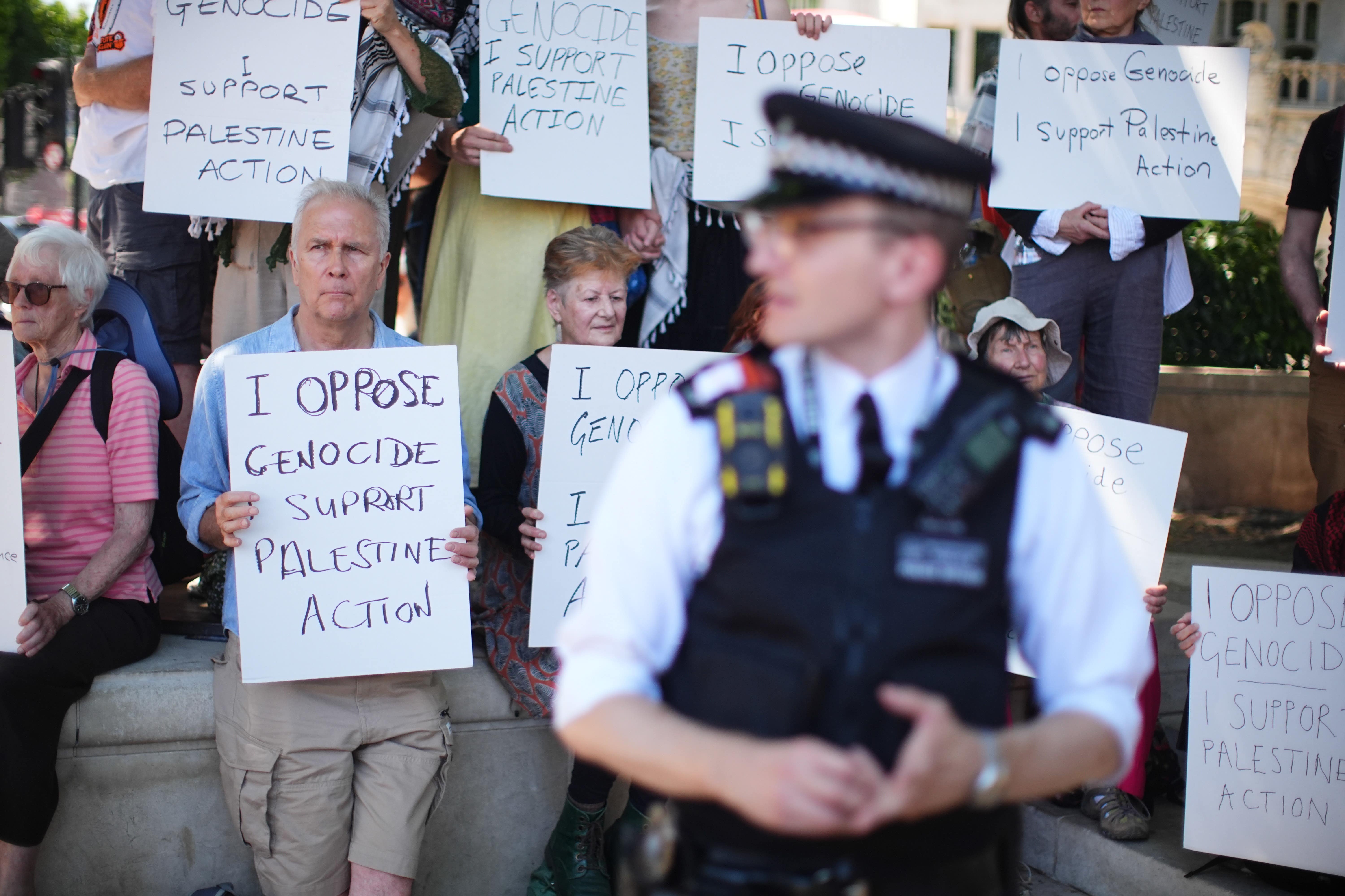 People take part in a protest in Parliament Square, London, to call for de-proscription of Palestine Action