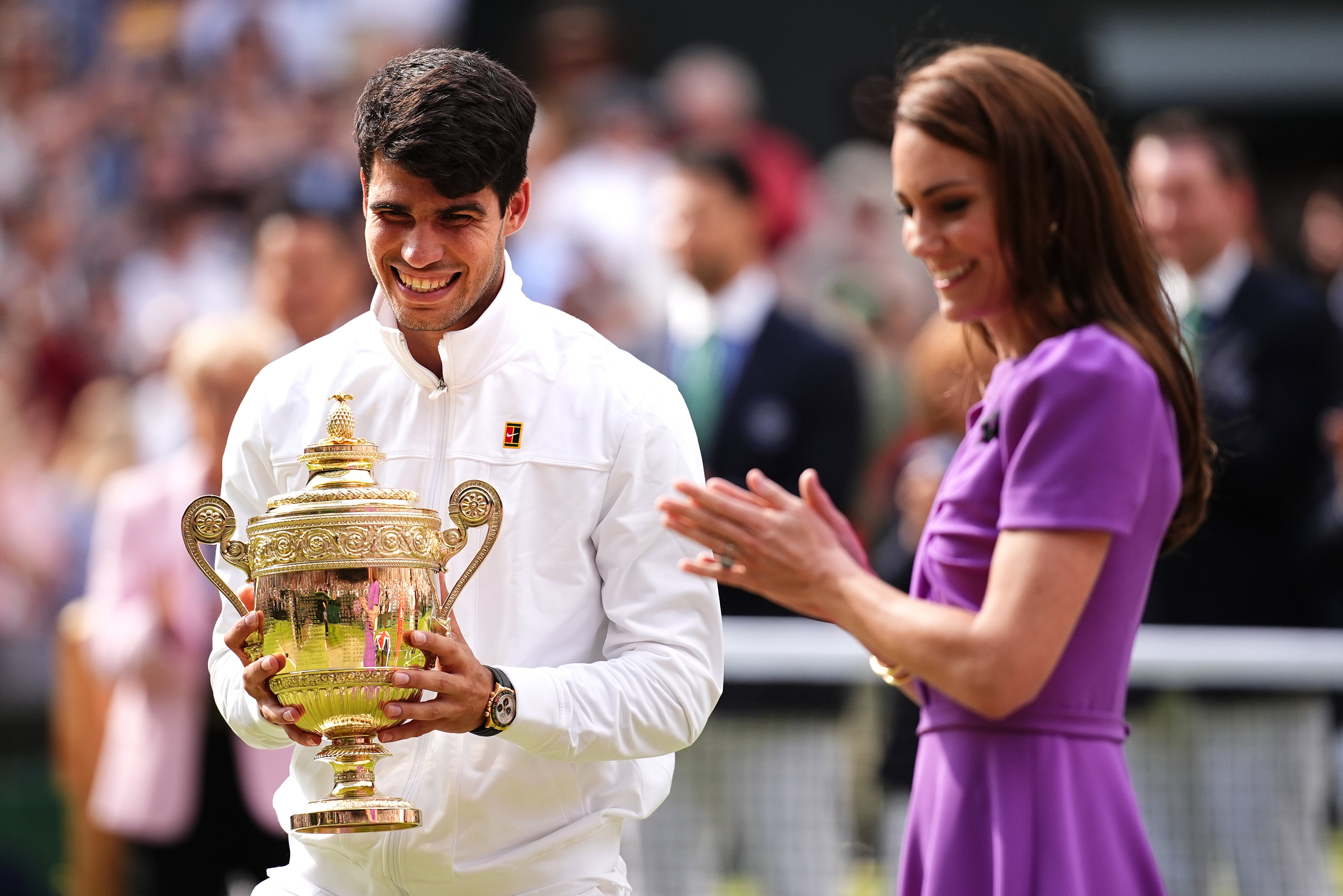 Carlos Alcaraz (left) is presented with the trophy by the Princess of Wales after victory in 2024 (Aaron Chown/PA)