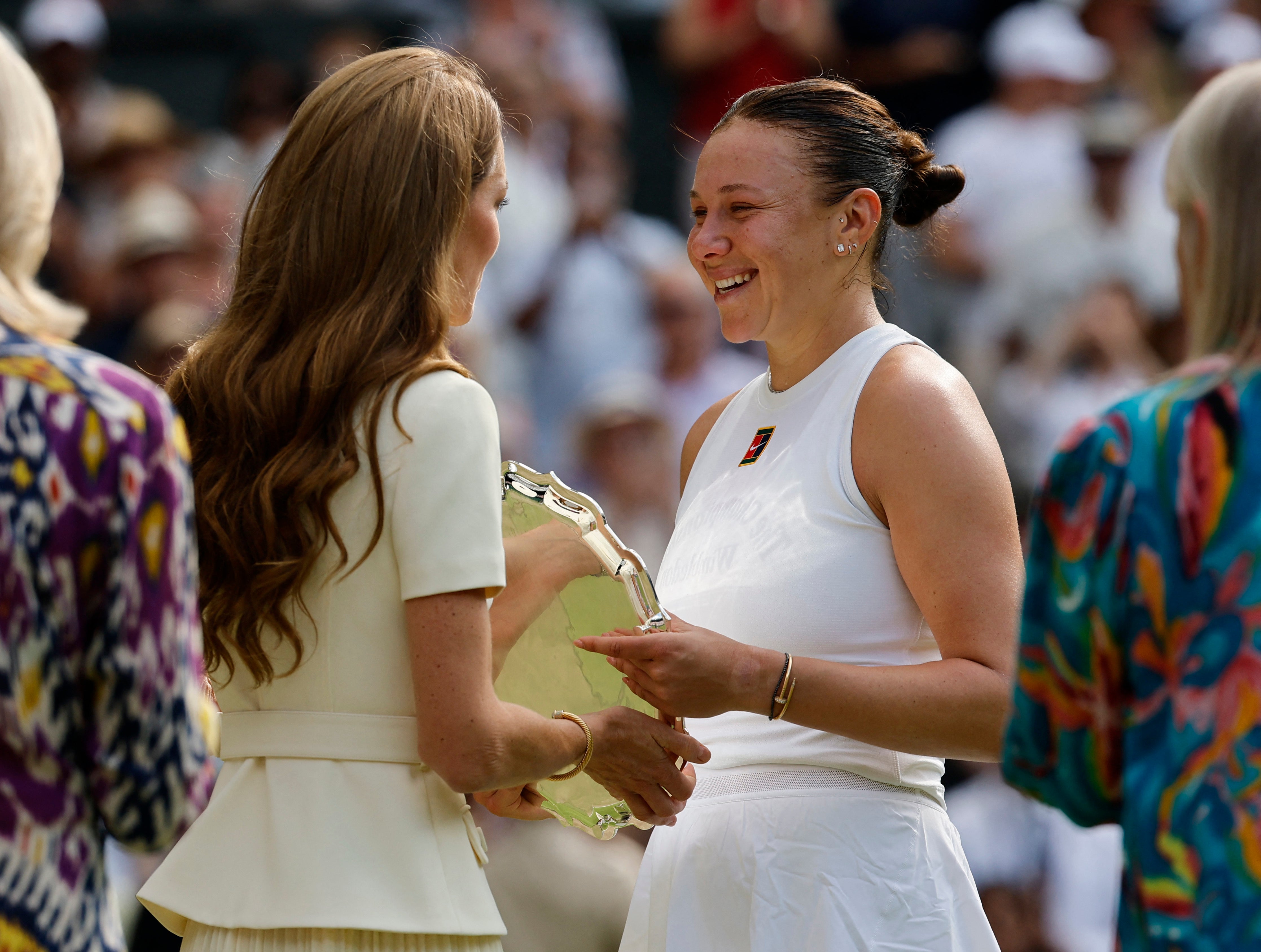 Britain's Catherine, the Duchess of Cambridge presents a trophy to runner up Amanda Anisimova