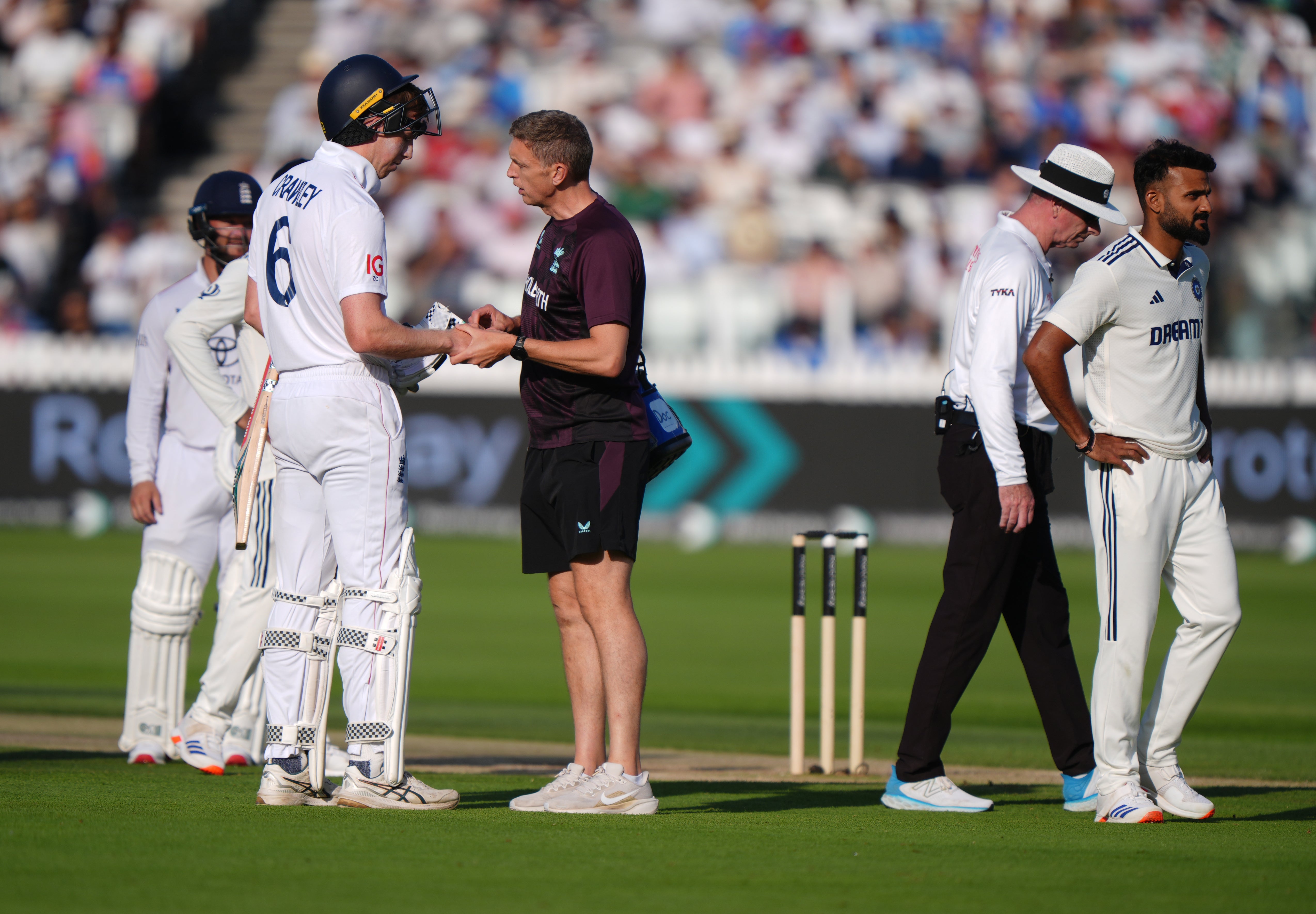 Zak Crawley has his finger checked by England’s physio in the final over (Bradley Collyer/PA)