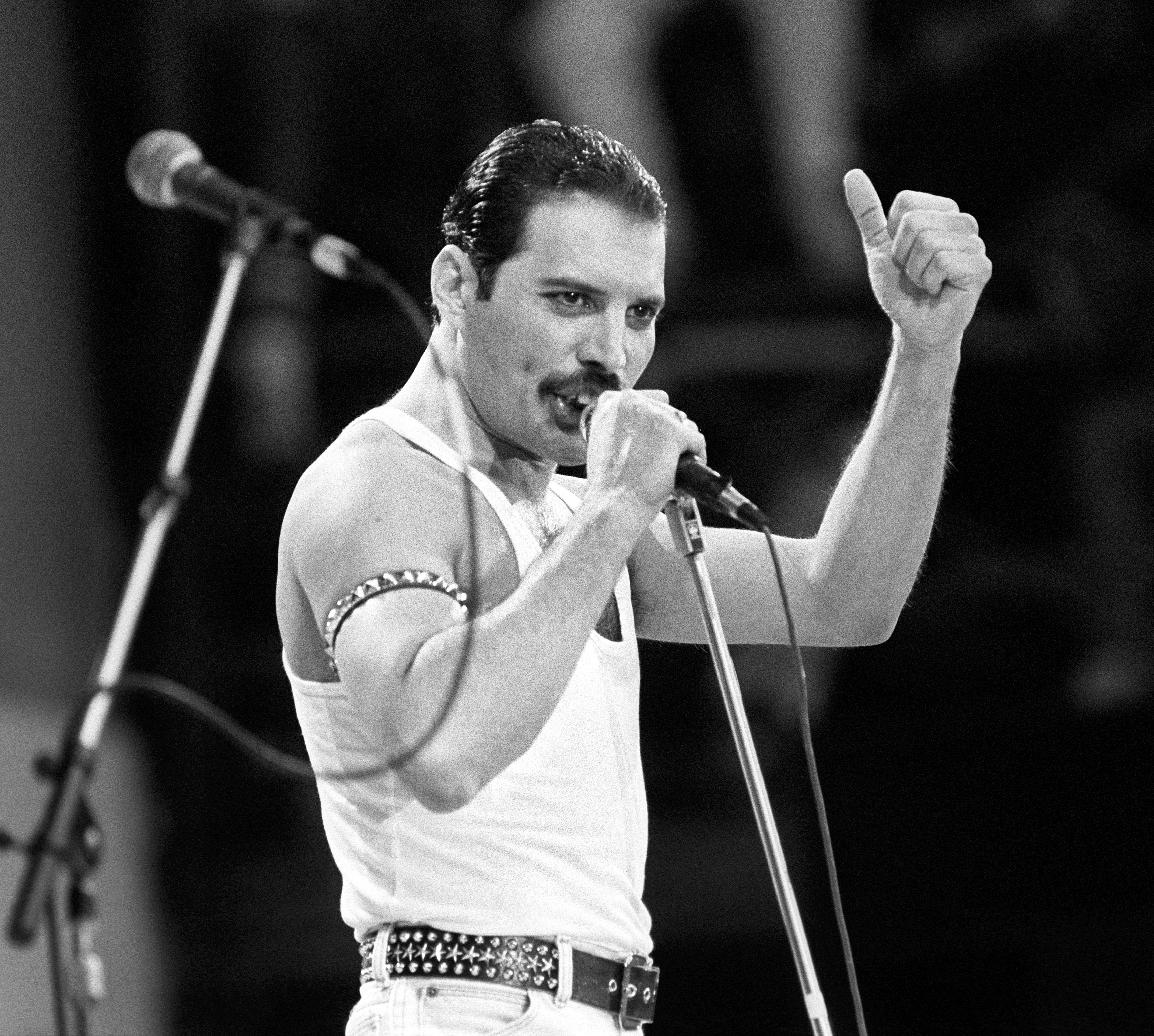 Freddie Mercury, of the rock-pop band Queen, performing on stage during the Live Aid concert