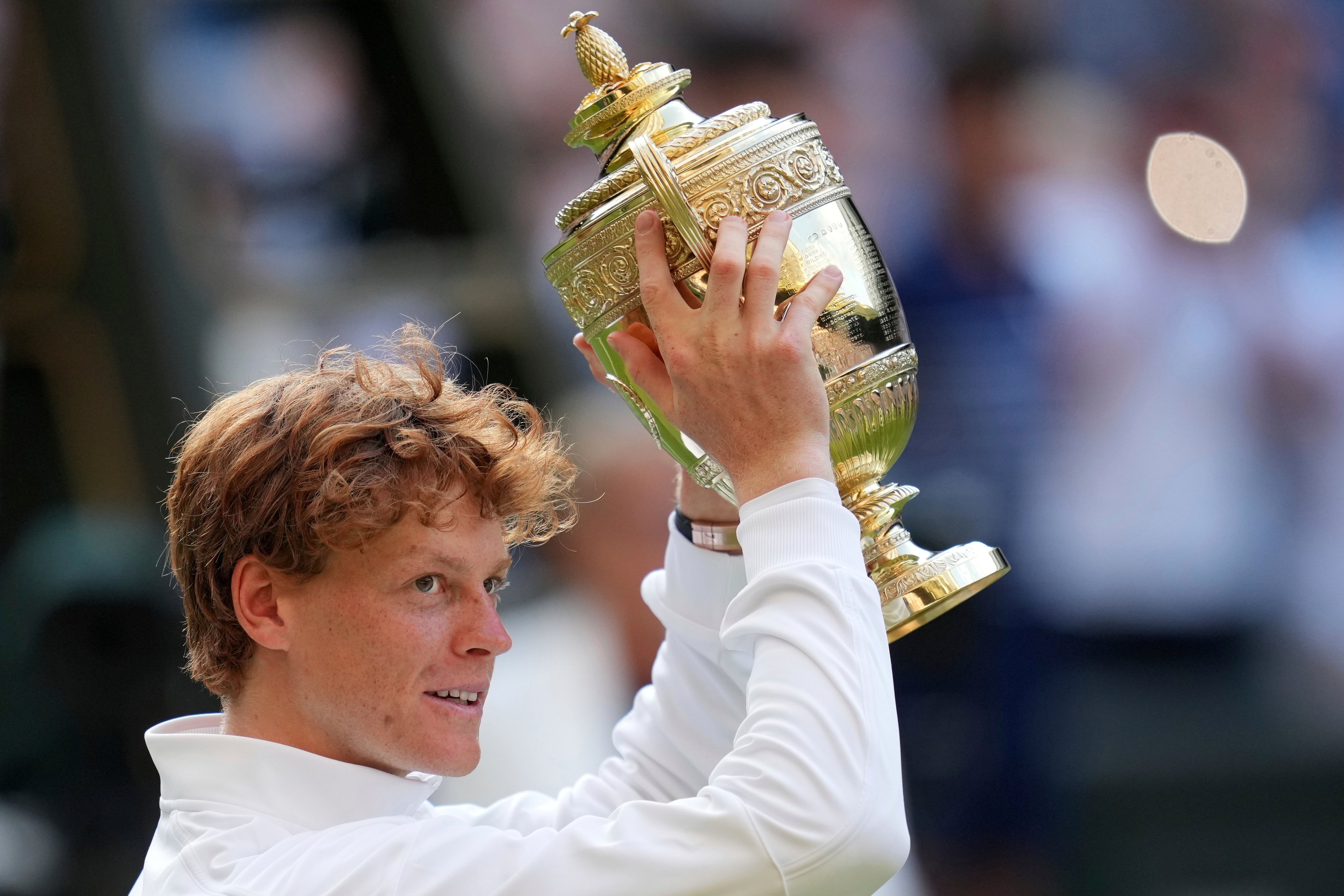 Sinner holds aloft the men’s singles trophy