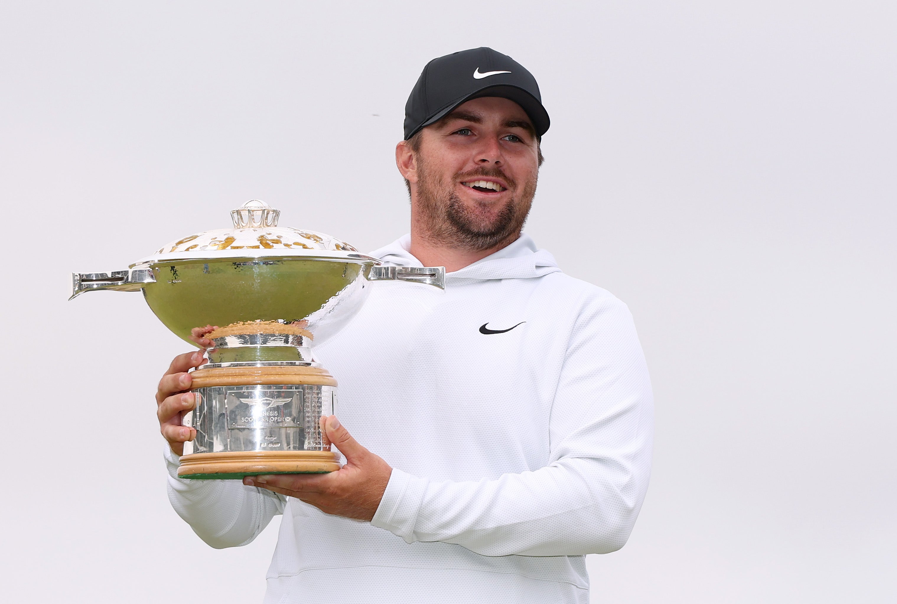 Chris Gotterup of the United States poses for a photograph with the Genesis Scottish Open 2025 trophy