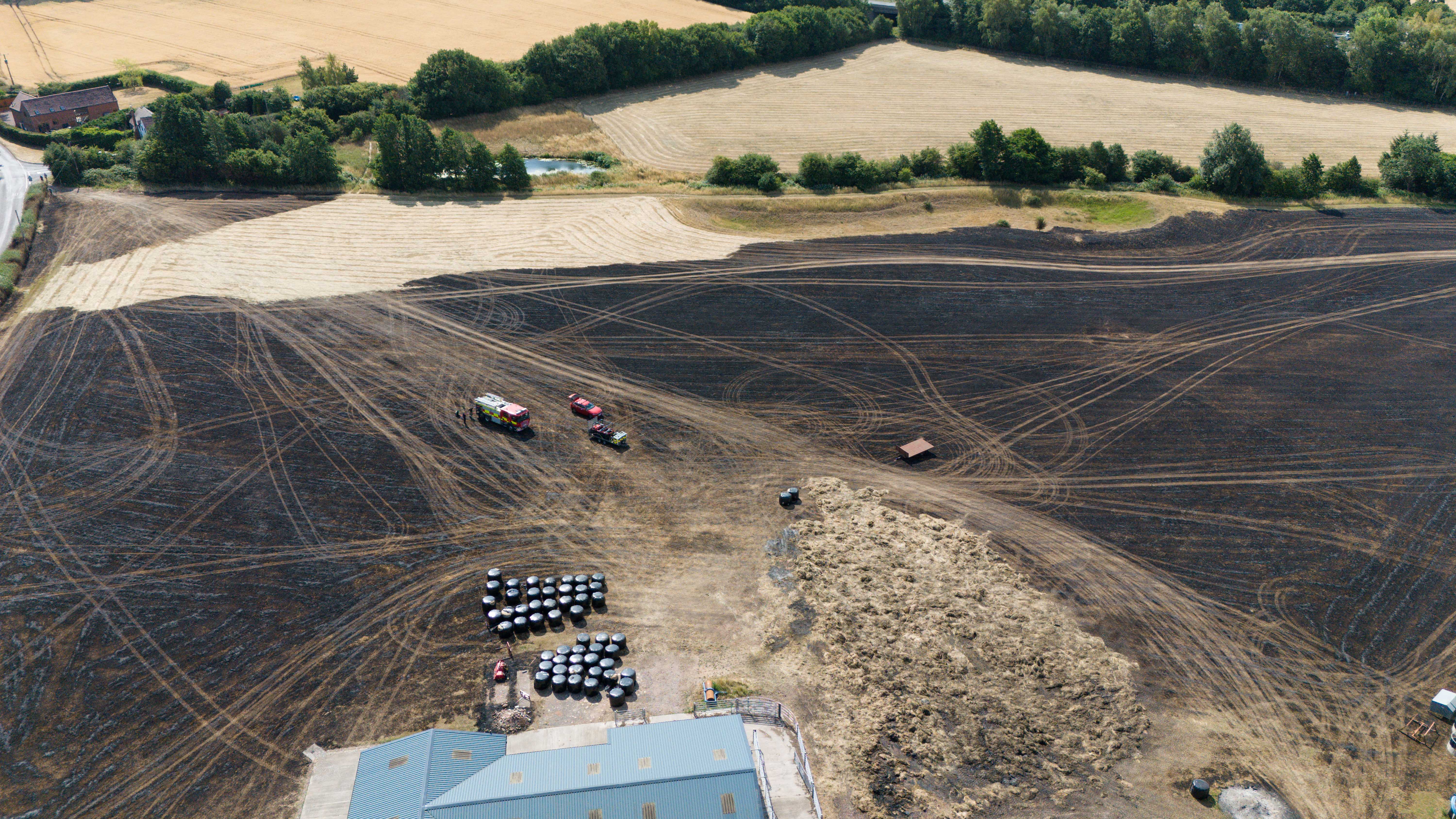 A torched field in Marlbrook, Worcestershire, is seen after homes were evacuated following a fire