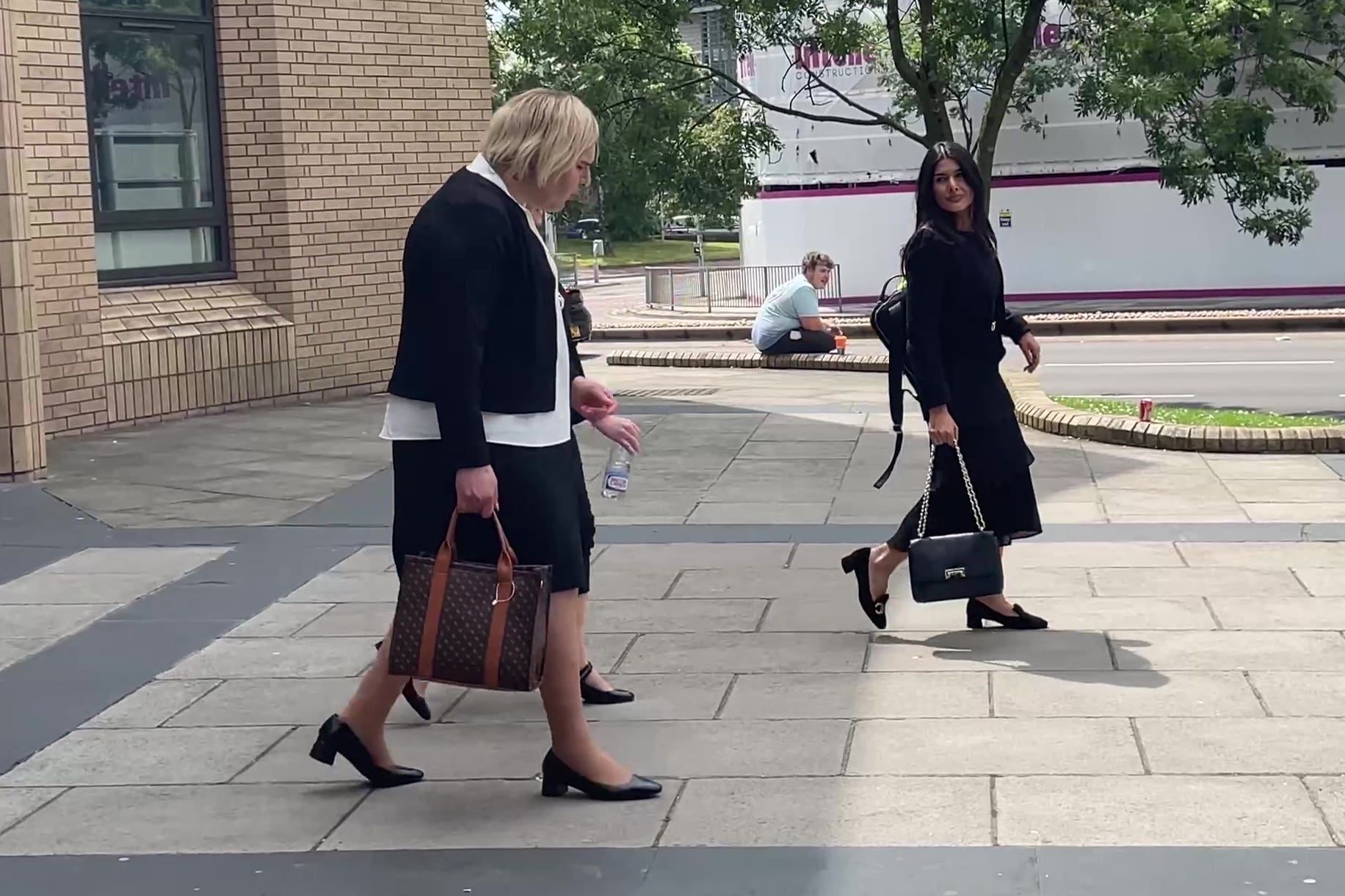 Katie Wallis, left, outside court
