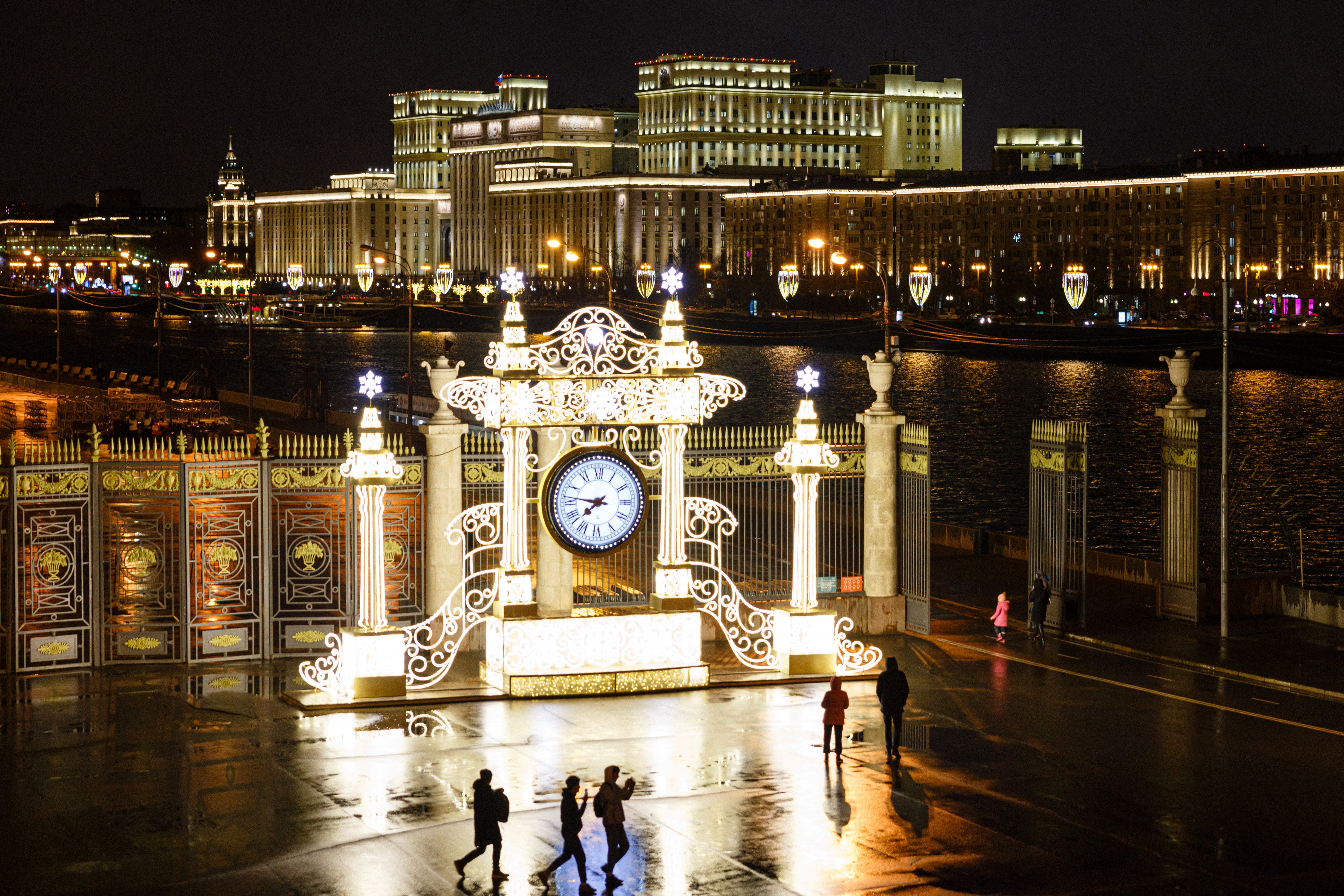 People walk in Gorky Park with the Russian Defence Ministry on the background in Moscow on February 22, 2022.