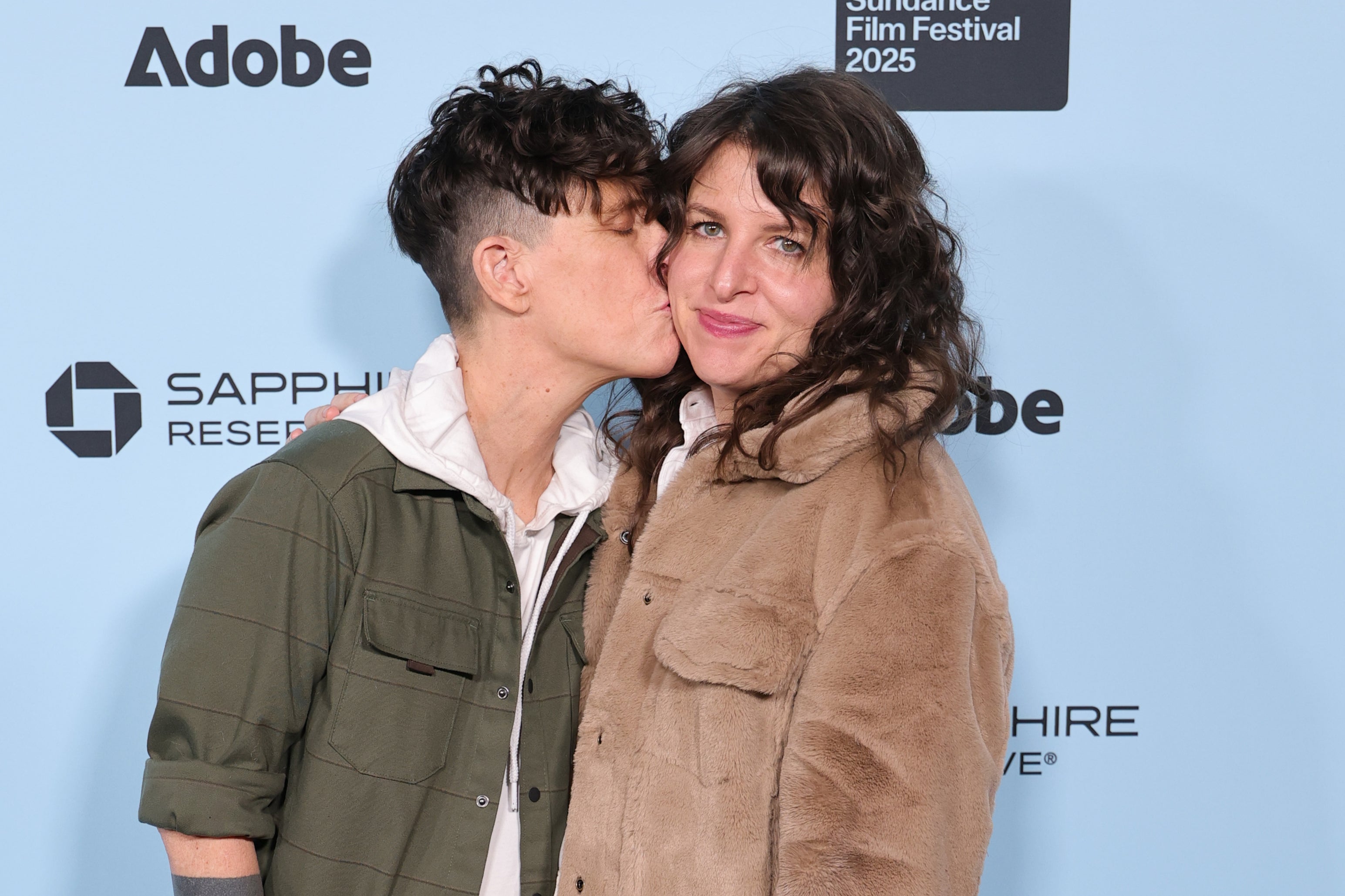 Andrea Gibson kissing their wife, Megan Falley, at the premiere of 'Come See Me In The Good Light' at the 2025 Sundance Film Festival