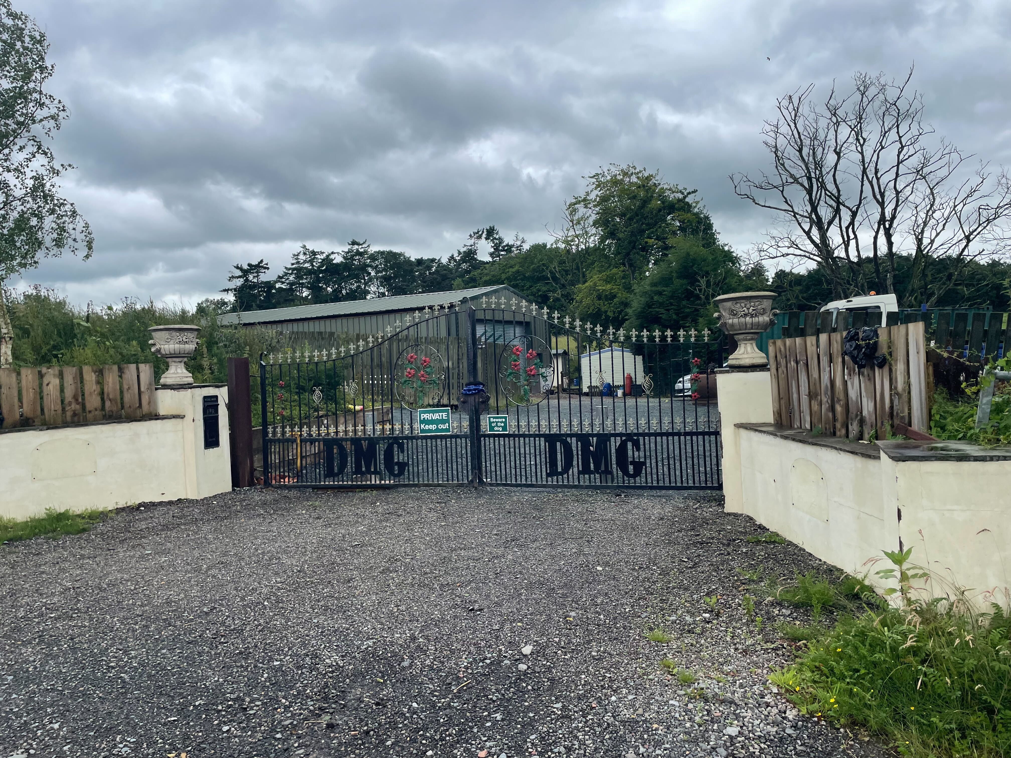 Daniel Graham's home was a caravan within a yard which had gates appearing to include his initials