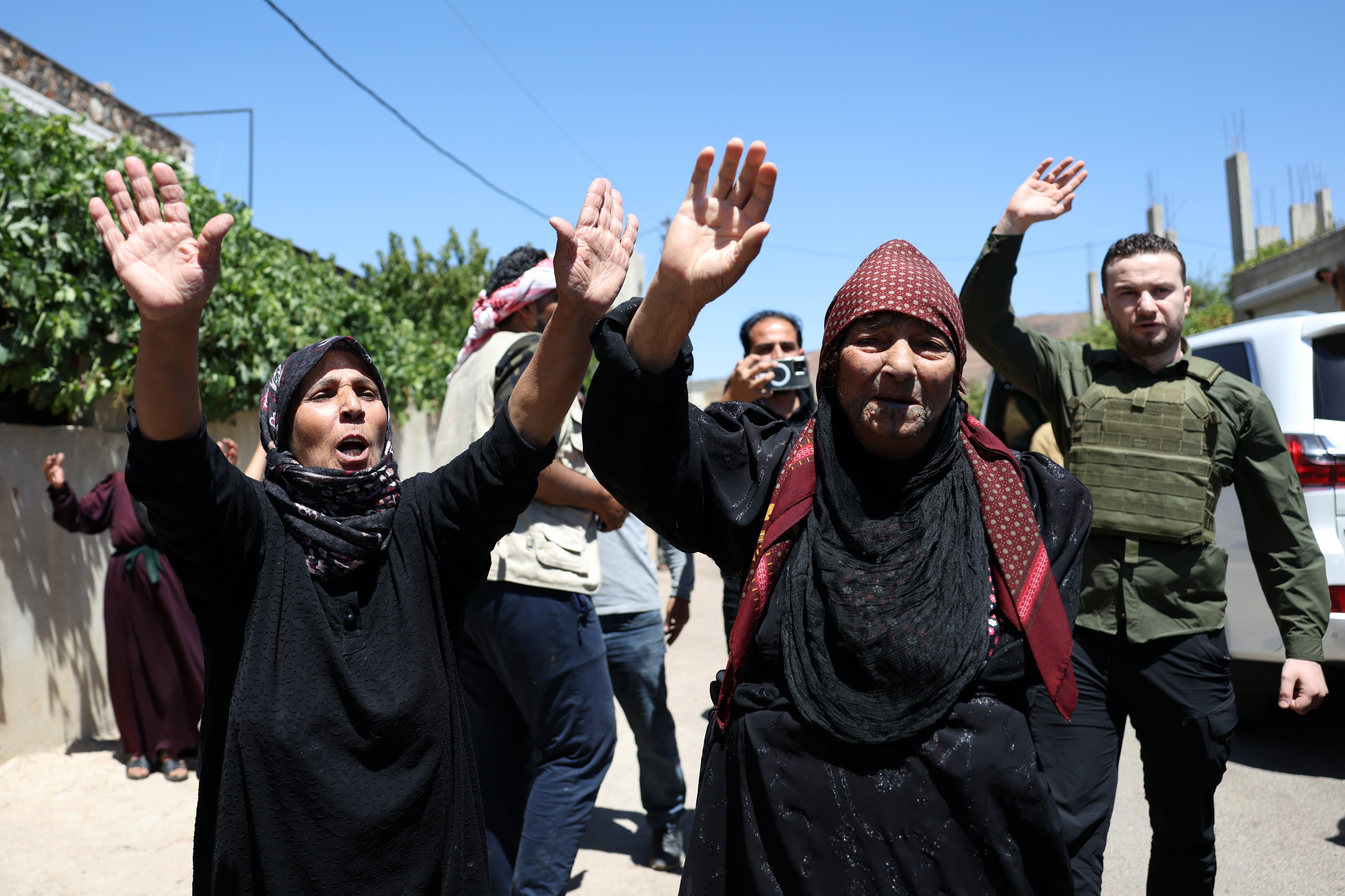 Bedouin celebrate the entry of the Syrian army in the Maqous neighbourhood of Sweida on Tuesday