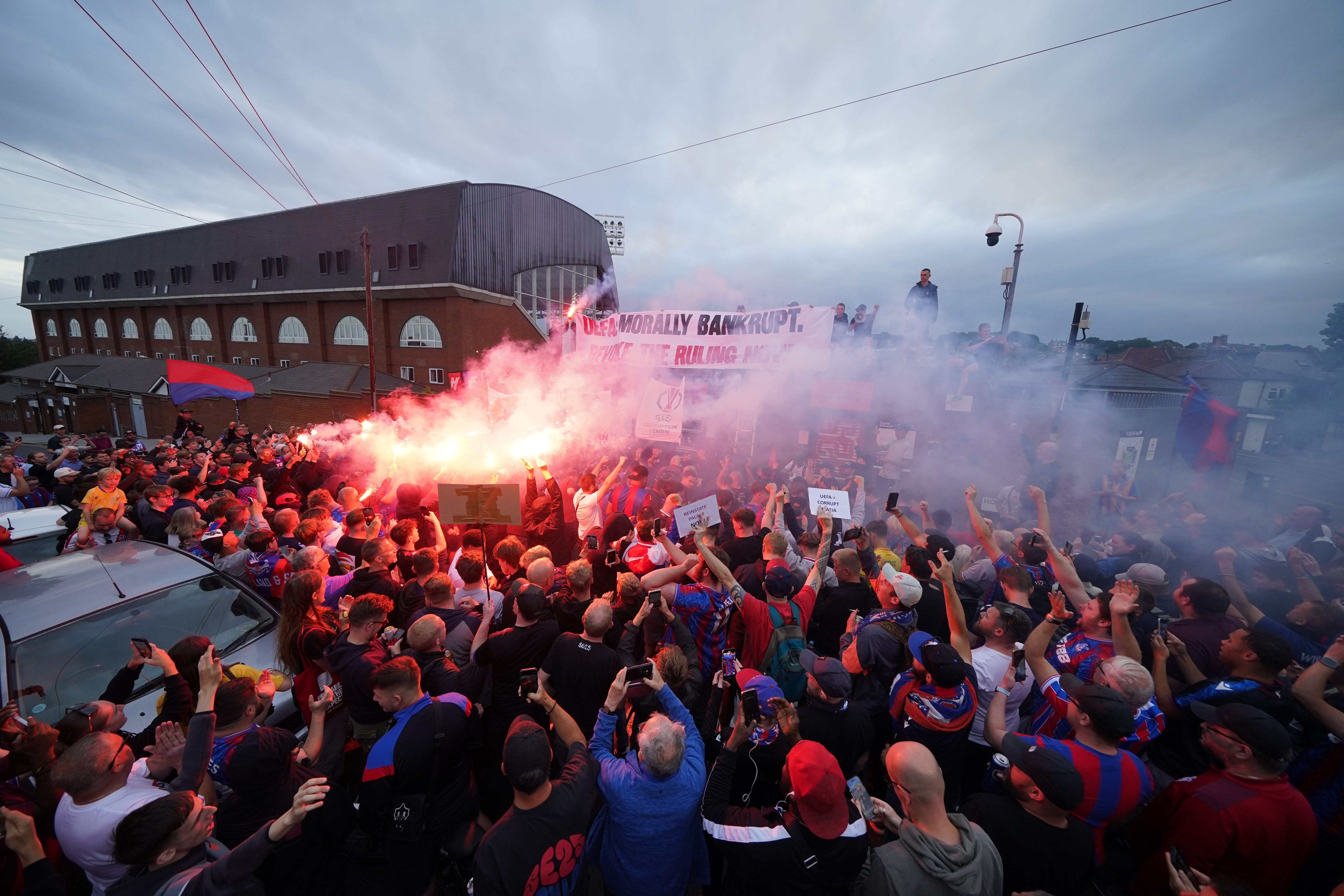 <p>Crystal Palace fans at the protest march (Yui Mok/PA)</p>