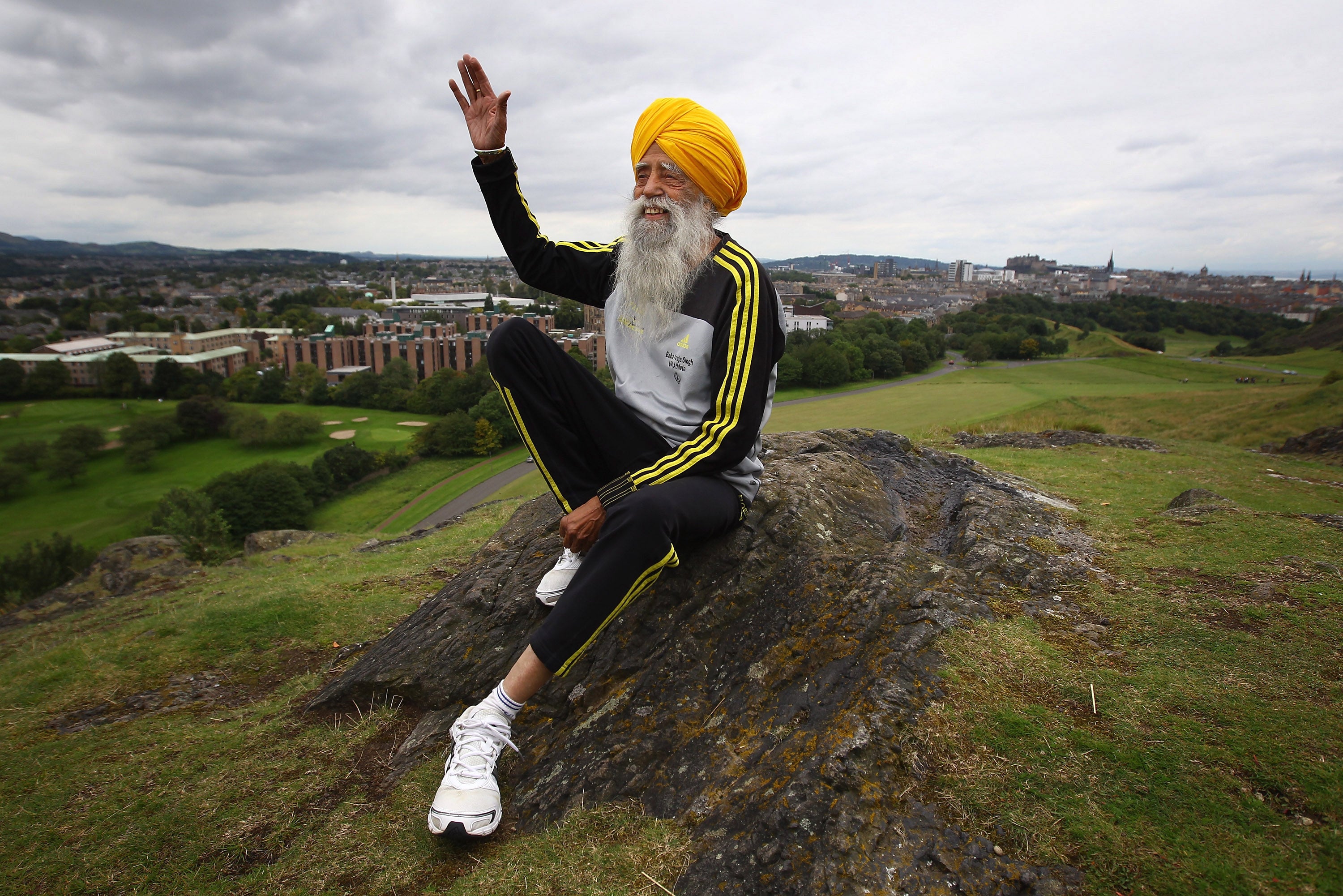 Centenarian Sikh runner Fauja Singh poses for pictures after being the first person to officially enter for next year's Edinburgh Marathon on September 1, 2011