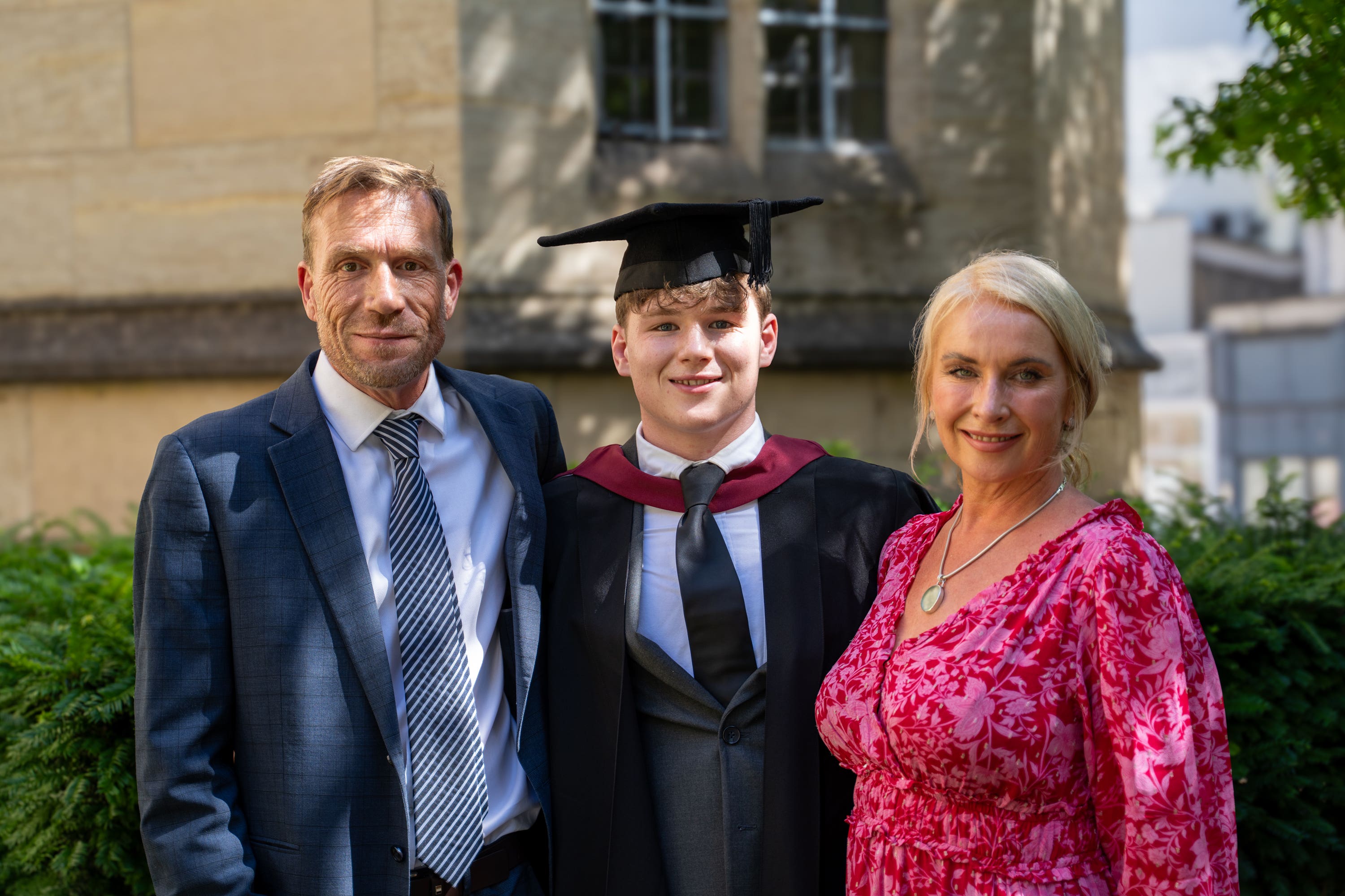 Archie Wills-Johnson with his parents Paul Johnson and Karen Wills celebrates his graduation (Nim Jethwa/University of Bristol/PA)