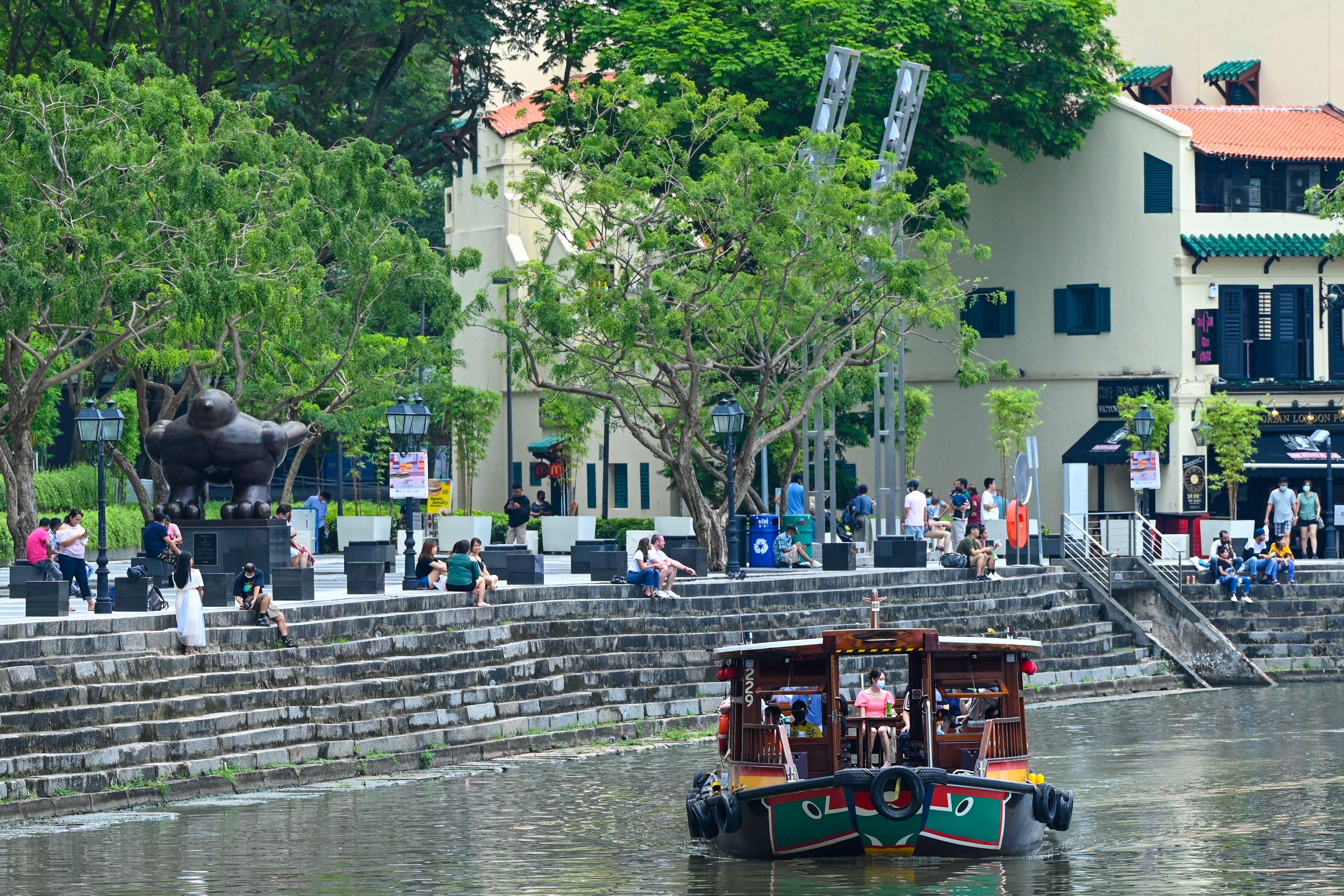 File. Tourists along the Singapore River