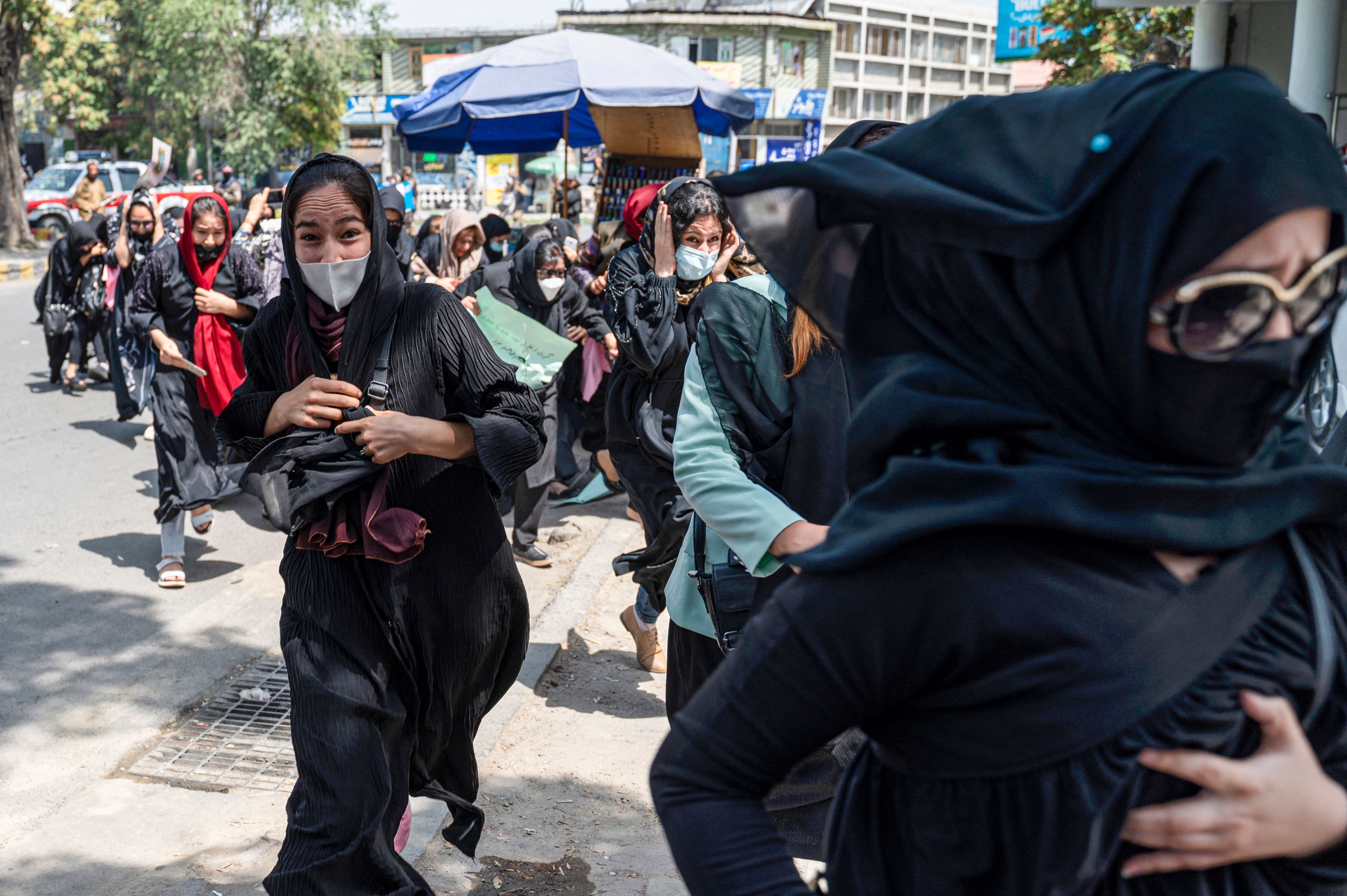 Taliban fighters fire into the air to disperse Afghan women protesters in Kabul, August 2022