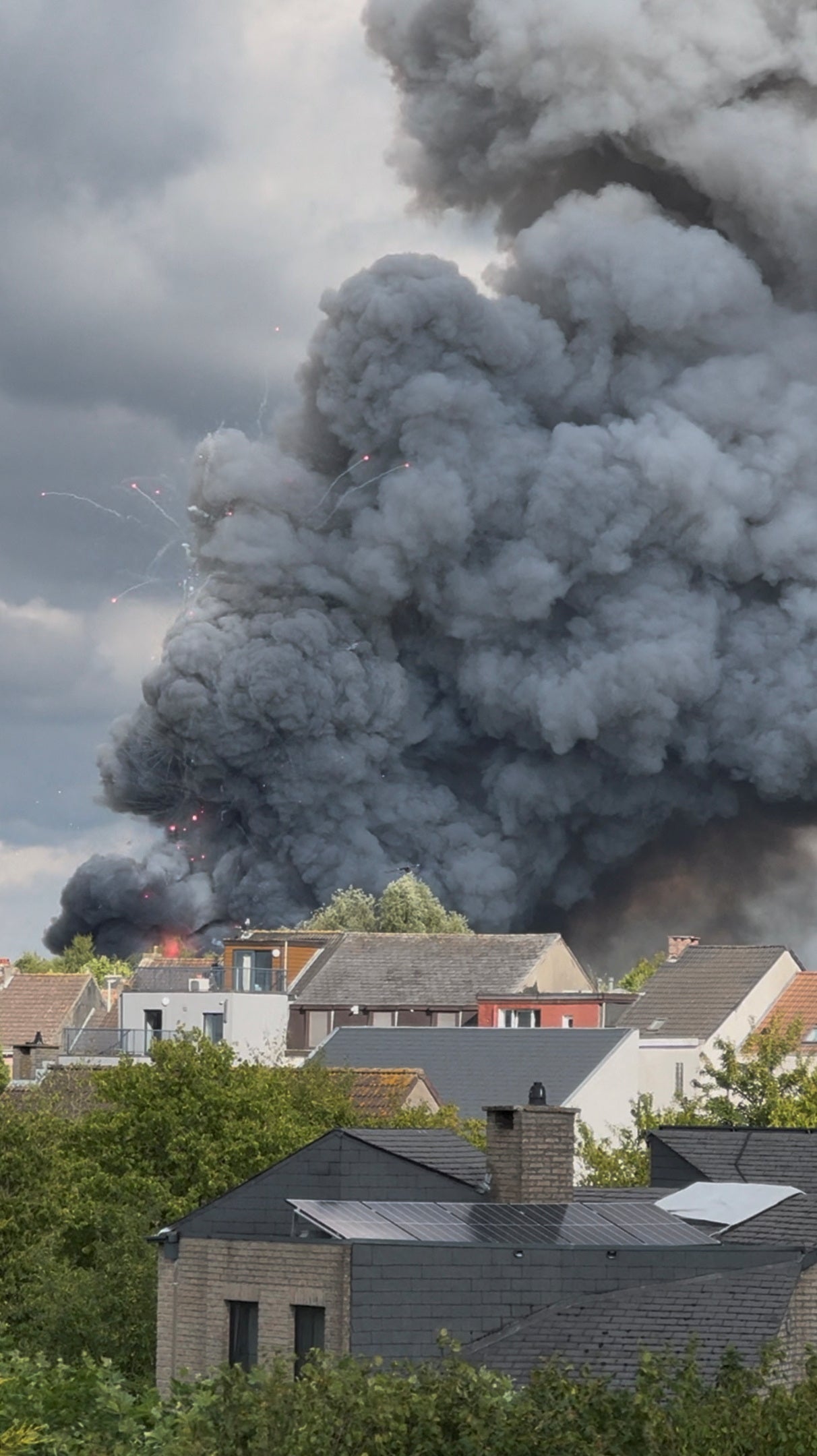 Fireworks burst and smoke rises as a fire engulfs the main stage of Tomorrowland, an electronic music event, in Boom, Belgium