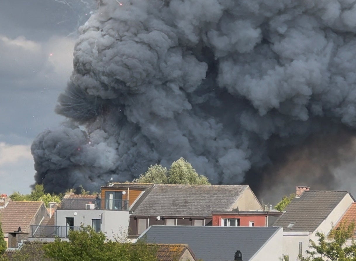 Fireworks burst and smoke rises as a fire engulfs the main stage of Tomorrowland, an electronic music event, in Boom, Belgium