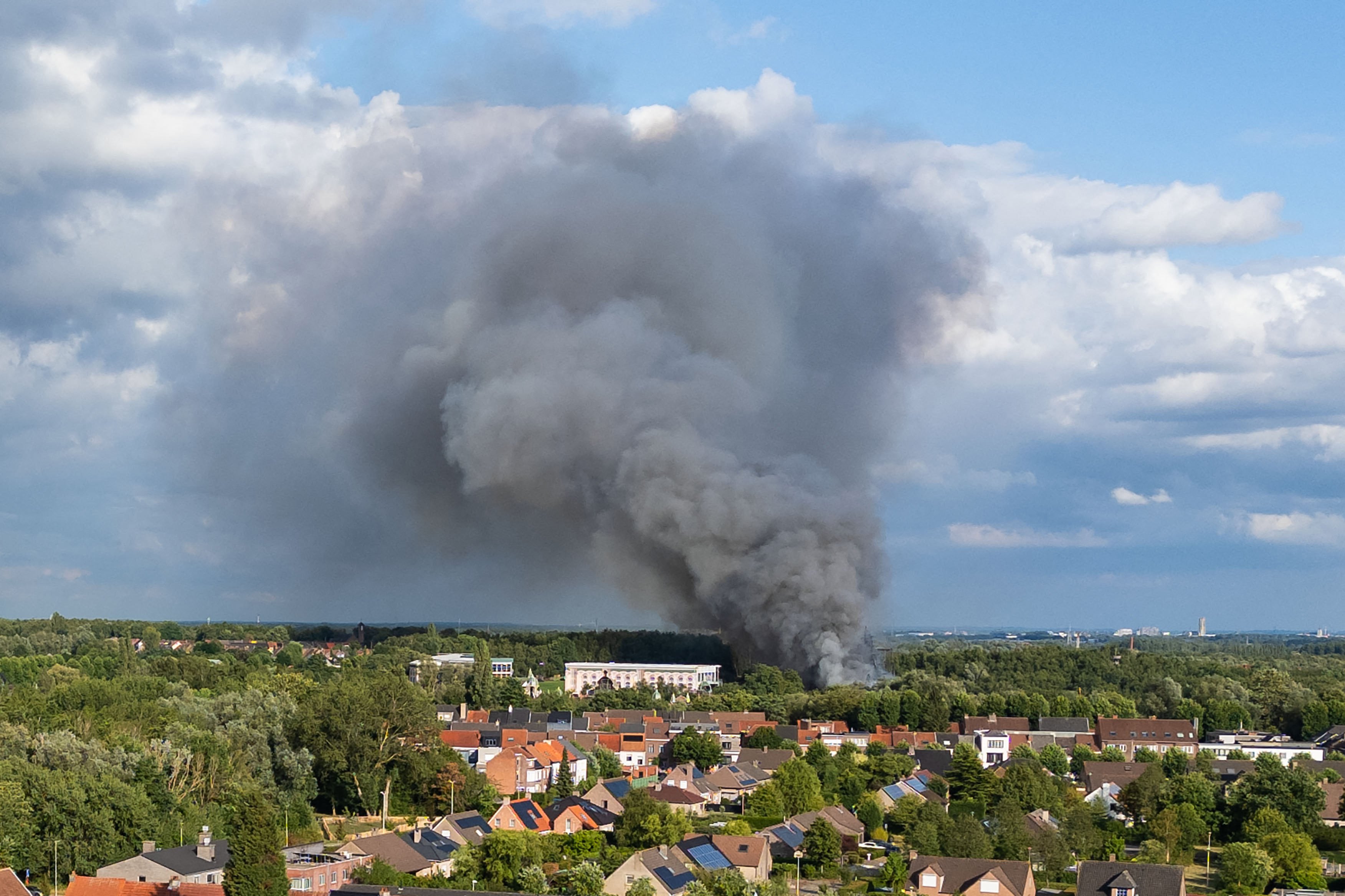 Smoke caused by a fire billows above the site of the Tomorrowland electronic music festival