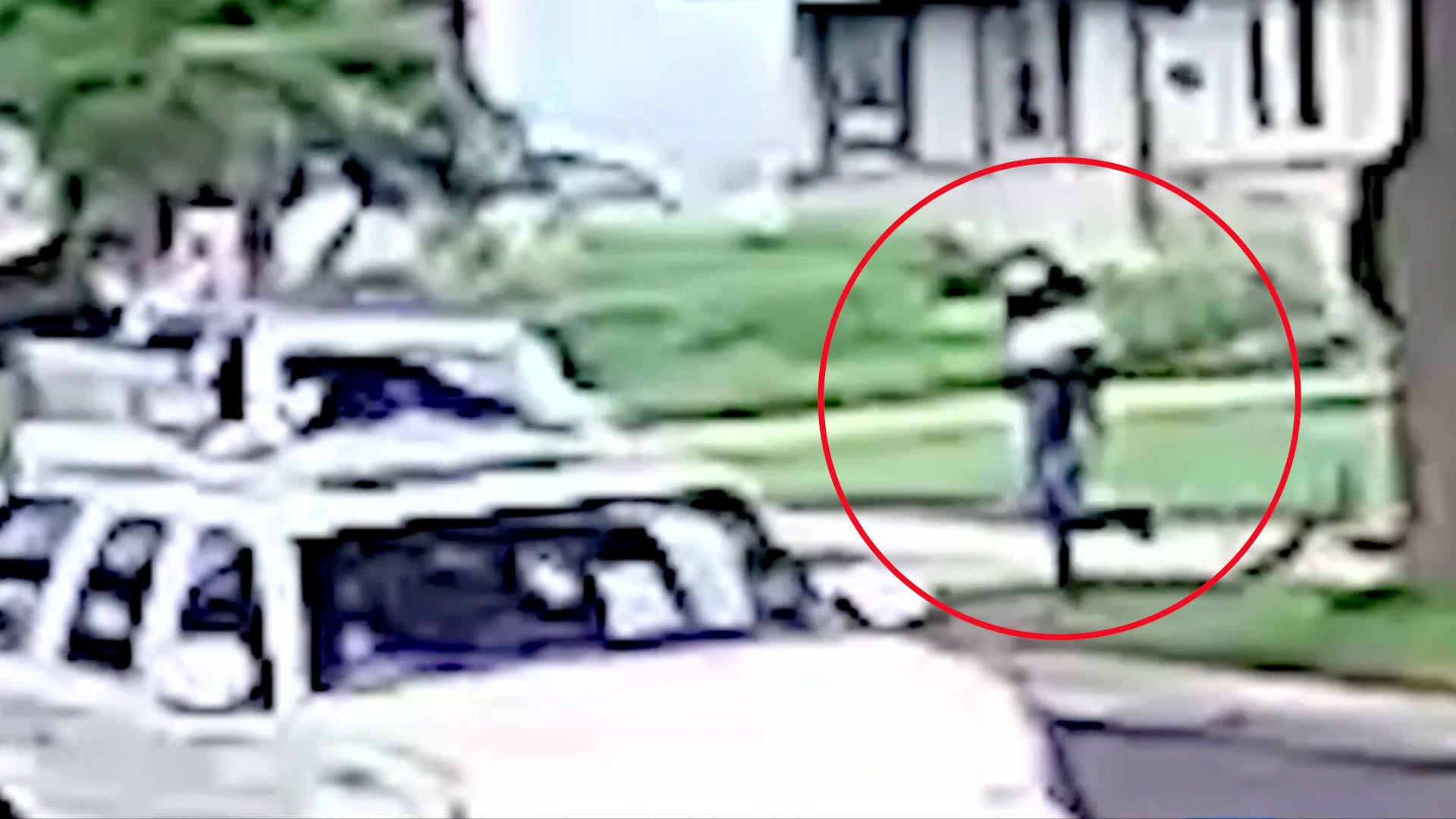 One suspect sprints after the child, grabs him, and races back to the Jeep with Jamal in his arms