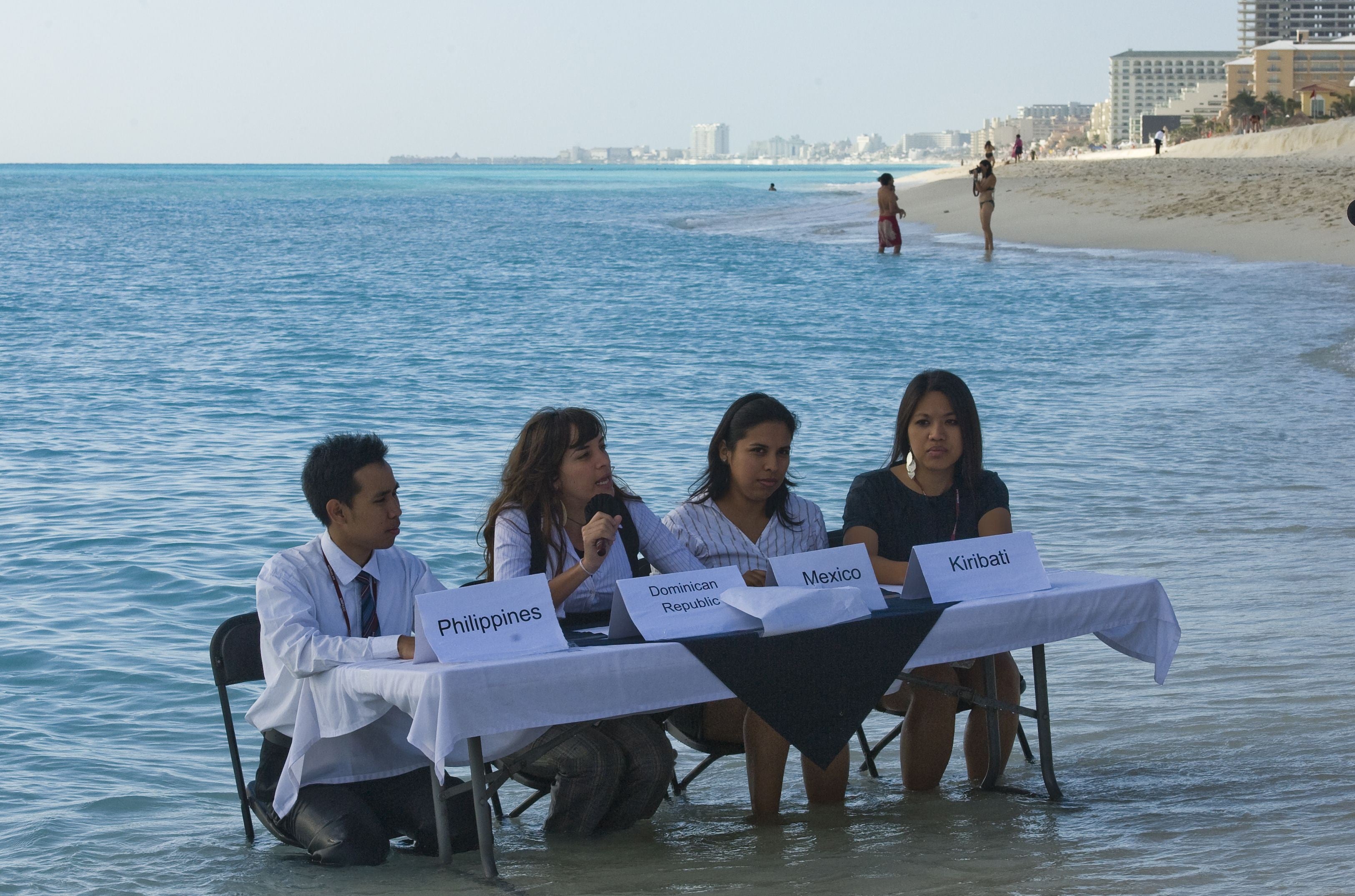 Delegations representing Philippines, Australian and Dominican Republic share a negotiation table regarding the islands in danger of disappearing due to the rising ocean levels caused by global warming, in the framework of the COP16 United Nations Climate Change conference on 9 December 2010
