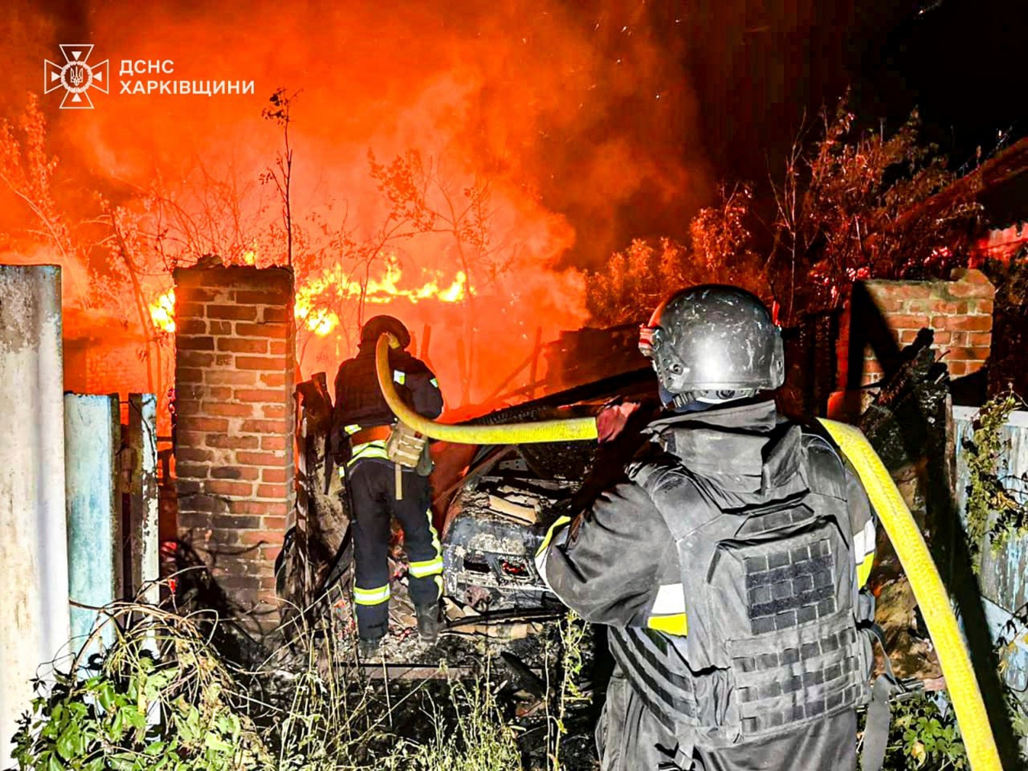 In this photo provided by the Ukrainian Emergency Service, firefighters try to put out a fire following a Russian attack in the Kharkiv region of Ukraine