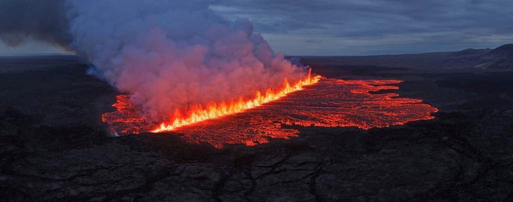 Lava emerges through a fissure following a volcano eruption near Grindavik, Reykjanes, Iceland
