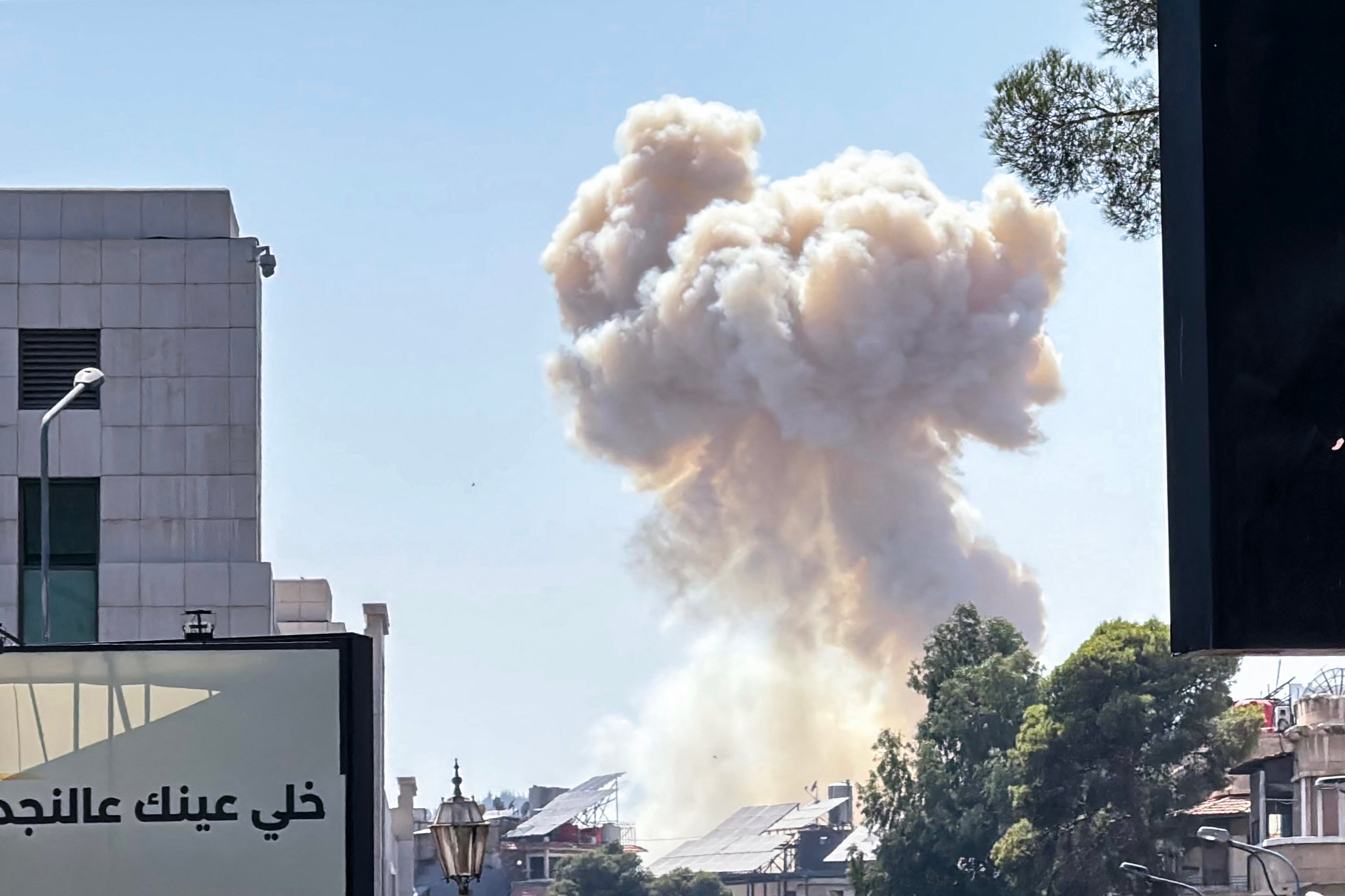 Smoke billows following Israeli strikes near the Syrian army and defence ministry headquarters