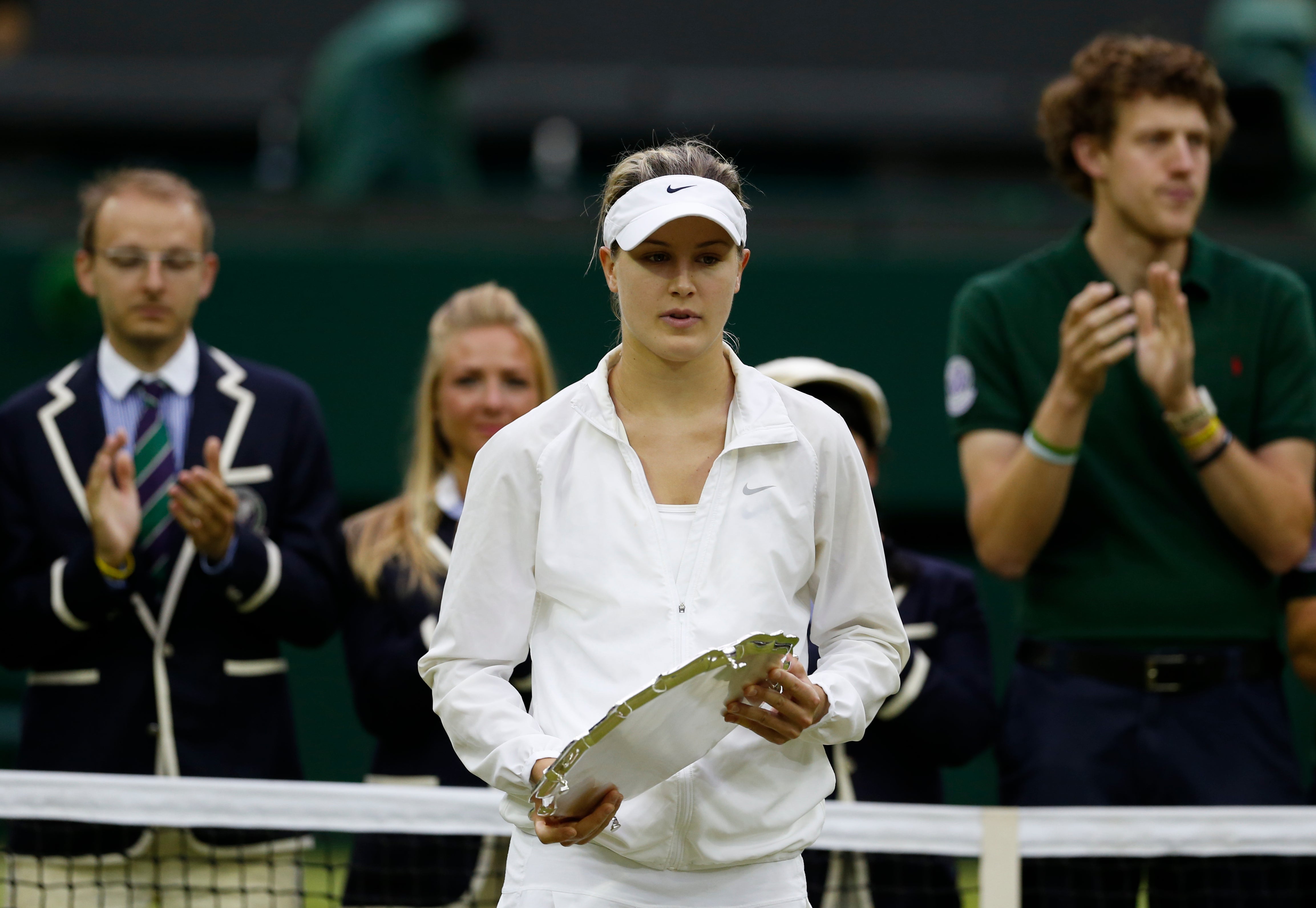 Eugenie Bouchard, of Canada, holds the runner's up trophy after losing to Petra Kvitova