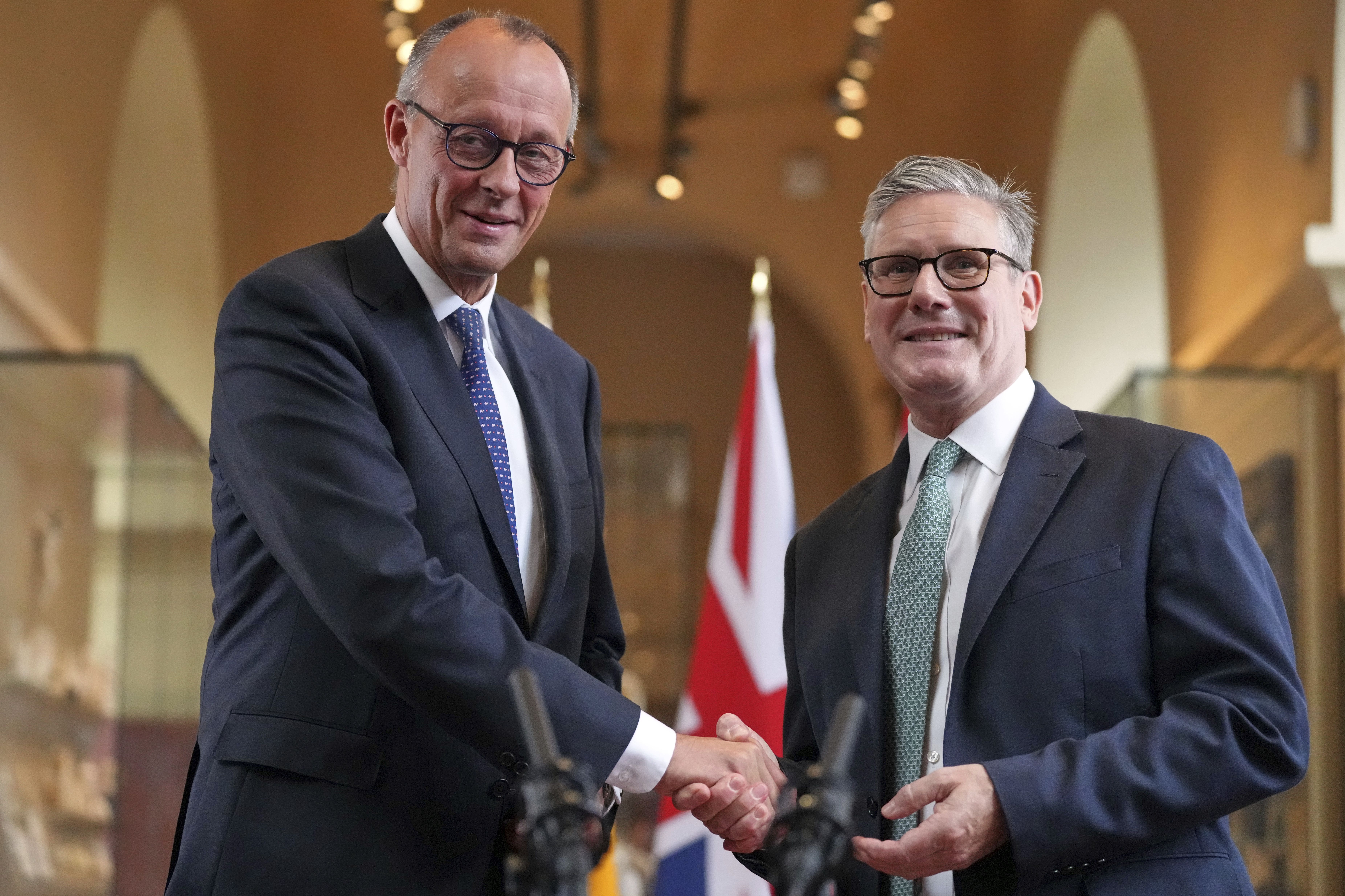 Prime Minister Sir Keir Starmer and German Chancellor Friedrich Merz shake hands as they sign the new UK-Germany treaty in London