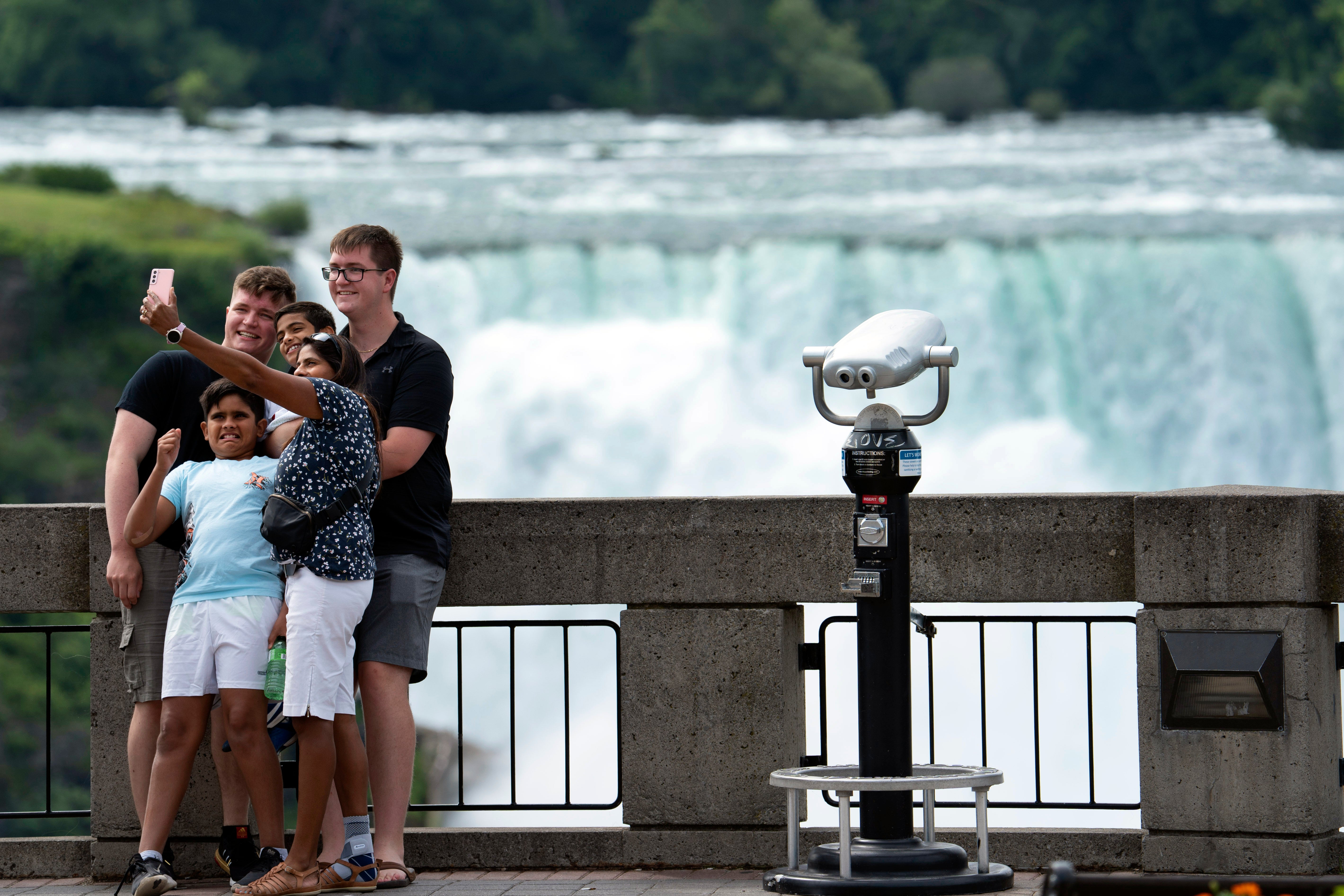 A family take a selfie at Niagara Falls, Ontario. The new plan intends to attract an ambitious 25 million visitors a year.